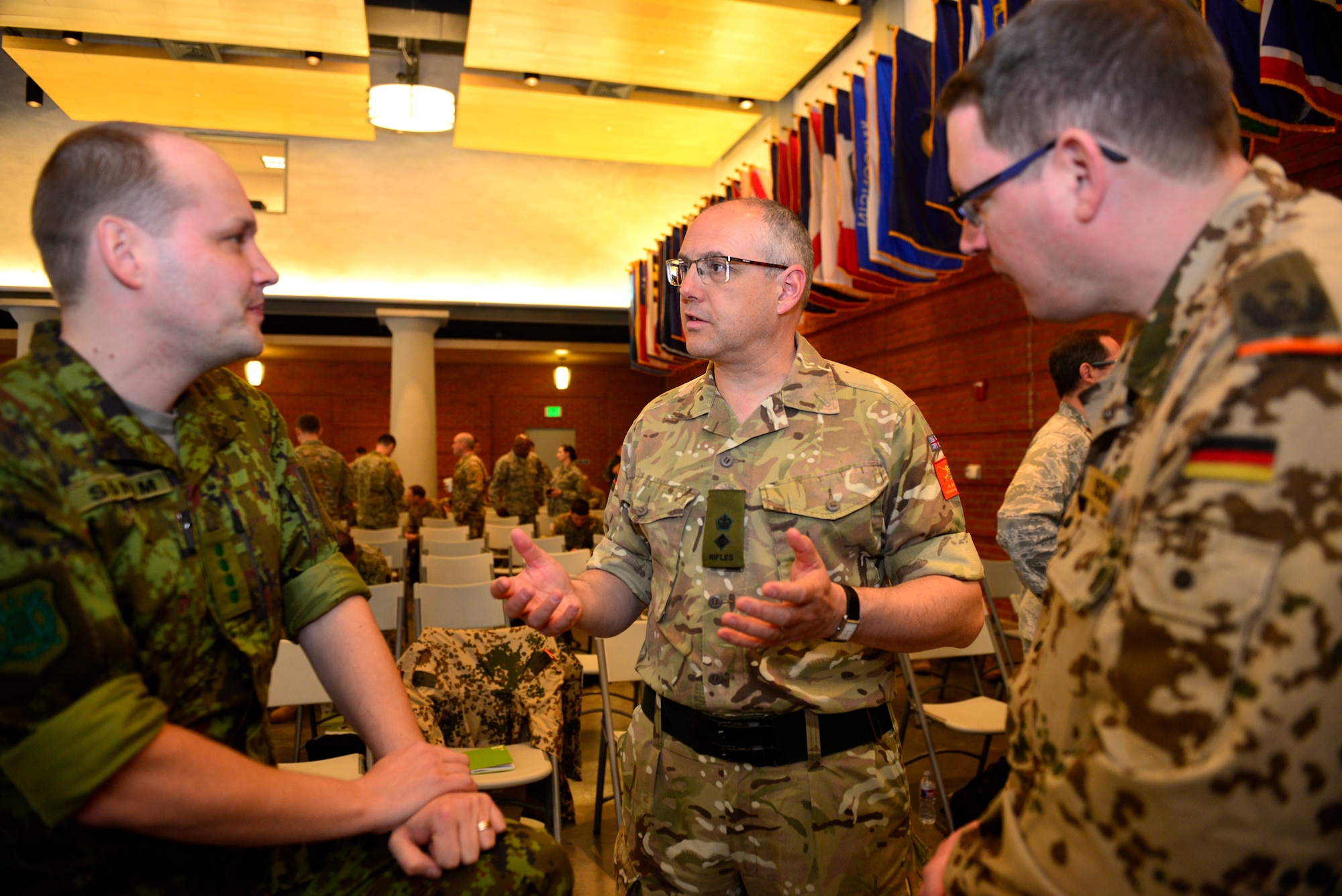 NEW ORLEANS -- United Kingdom Army Reserve Lt Col John Skiros, center, speaks with Estonian Army Capt Tony Sonum, left, and German Army Lt Col Axel Schmidt about the Military Reserve Exchange Program during a conference break. U.S. military members from around the nation gathered at Jackson Barracks in New Orleans today for an informational meeting about the Military Reserve Exchange Program. (U.S. Navy Photo by Chief Mass Communication Specialist Roger S. Duncan)