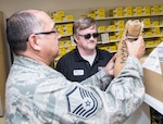 Philip Myers, 502nd Logistics Readiness Squadron Base Supply Center cashier, helps a customer with a pair of boots March 26, 2019, Joint Base San Antonio-Lackland, Texas.