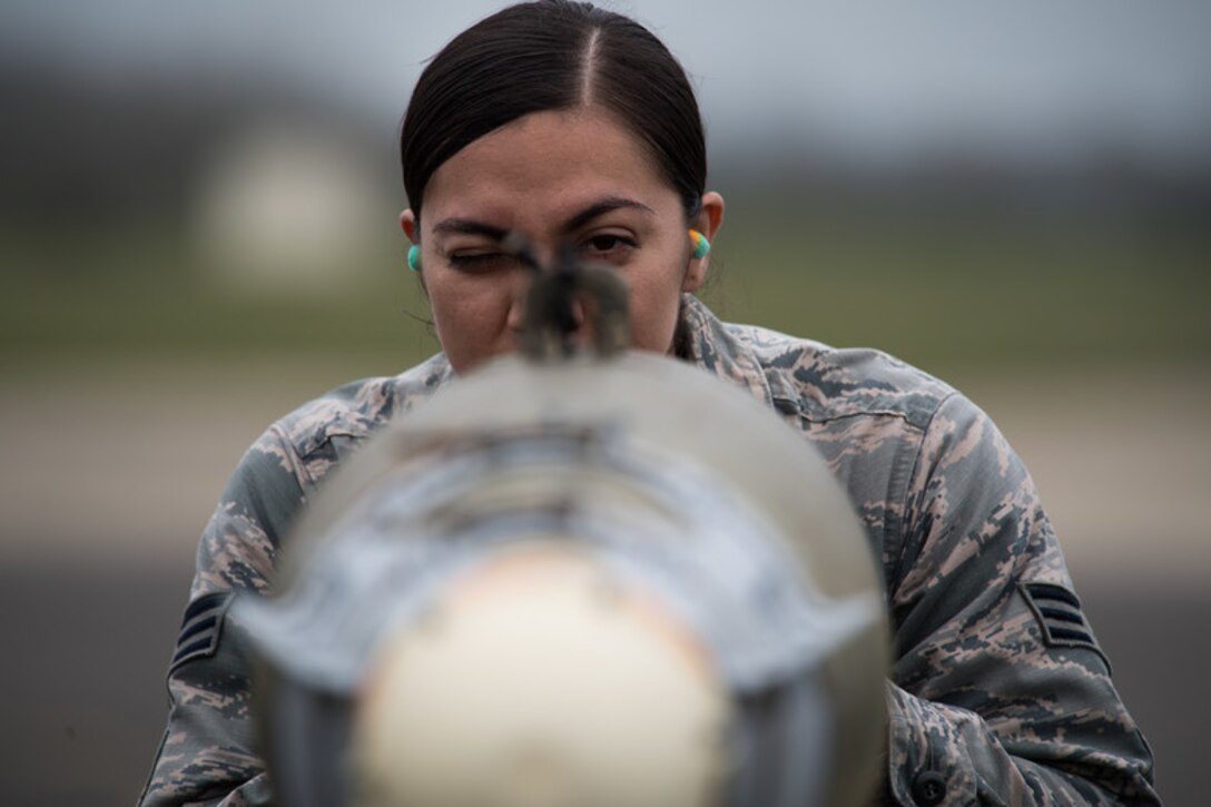 Senior Airman Angelica Melendez, 2nd Munitions Squadron conventional maintenance crew chief deployed from Barksdale Air Force Base, La., looks down a Guided Bomb Unit-38 at RAF Fairford, United Kingdom, March 21, 2019. Certain components on the GBU-38s had specific ways to be lined up once attached. Melendez checked to ensure those components were correctly placed. (U.S. Air Force photo by Airman 1st Class Tessa B. Corrick)