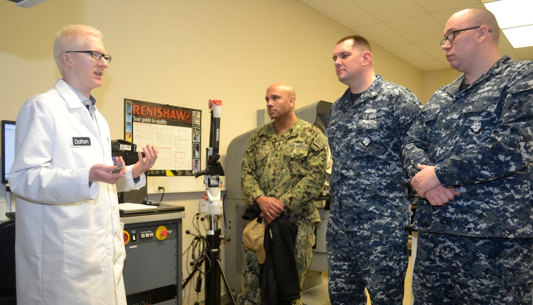 DLA Troop Support Product Test Center Analytical engineer Edward Dalton, far left, explains a PTC-A testing process for reflectivity of materials to a group of sailors assigned to Naval Support Activity Philadelphia April 3, 2019 in Philadelphia.