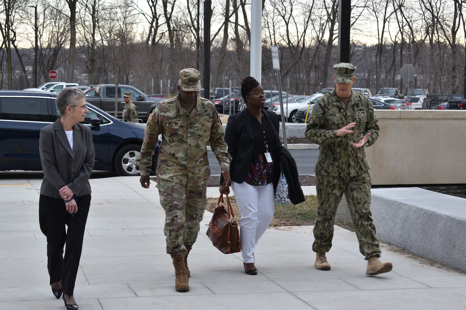 Two women and two military men walking on the grounds of DLA Distribution.