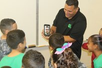 Puerto Rico Children talk with U.S. Soldier in Poland