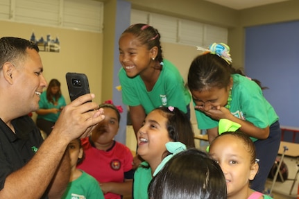 Puerto Rico Children talk with U.S. Soldier in Poland