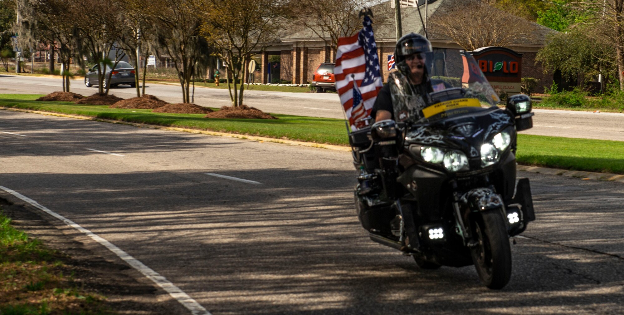 U.S. Army retired Sgt. Maj. Doug Iyvere rides down a street for the Green Knights Military Motorcycle Club poker run ride March 30, 2019.