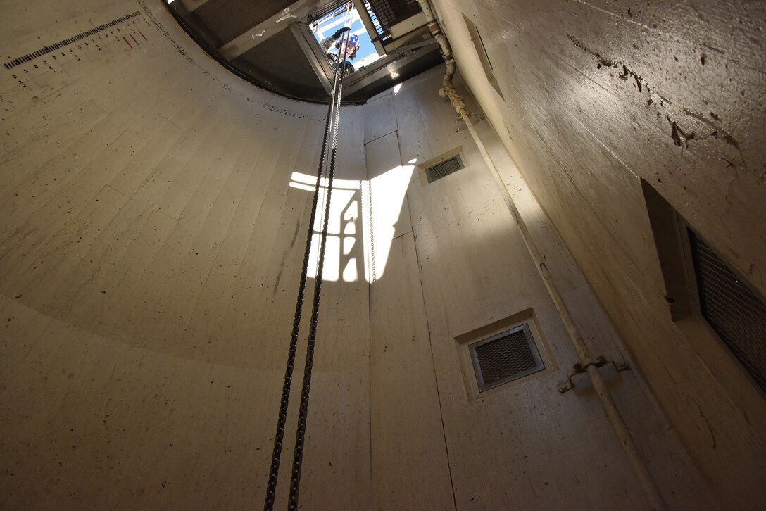 Airman 1st Class Sean Moore, 741st Maintenance Squadron mechanical and pneudraulics section technician, guides down a chain and hoist from a payload transporter to a tensioner March 18, 2019, at Malmstrom Air Force Base, Mont.