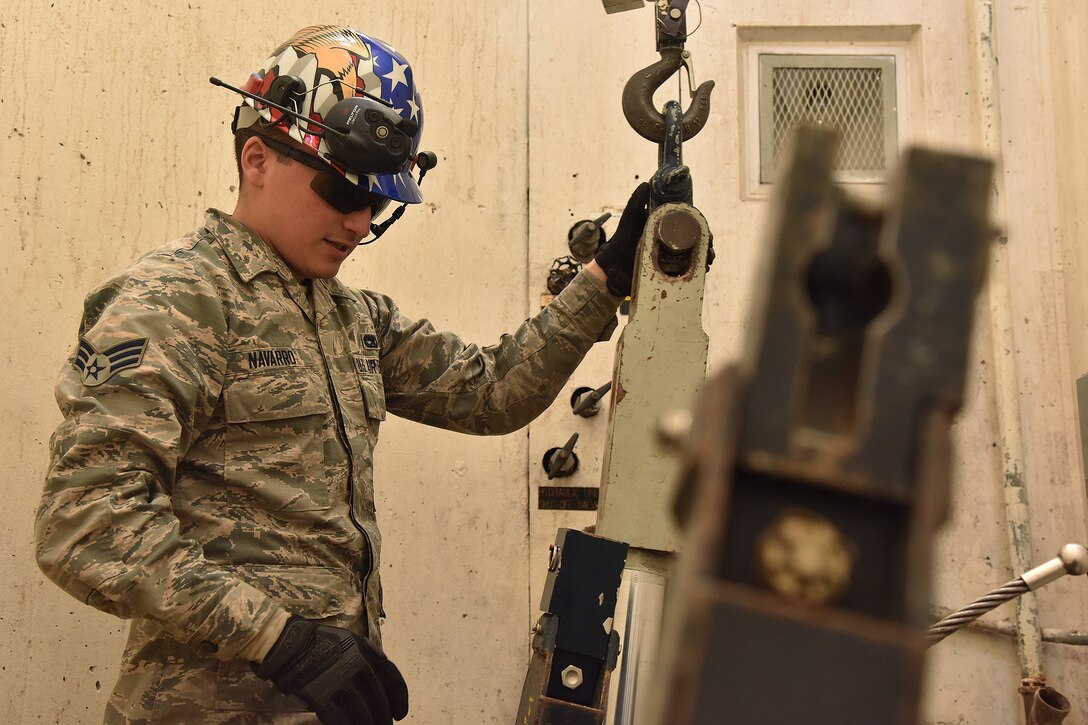 Senior Airman Steven Navarro, 741st Maintenance Squadron mechanical and pneudraulics section team chief, hooks a hoist from a payload transporter to a tensioner March 18, 2019, at Malmstrom Air Force Base, Mont.