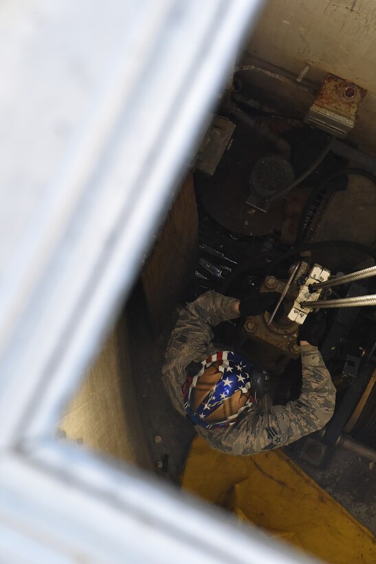Senior Airman Steven Navarro, 741st Maintenance Squadron mechanical and pneudraulics section team chief, hooks a hoist from a payload transporter to a tensioner March 18, 2019, at Malmstrom Air Force Base, Mont.