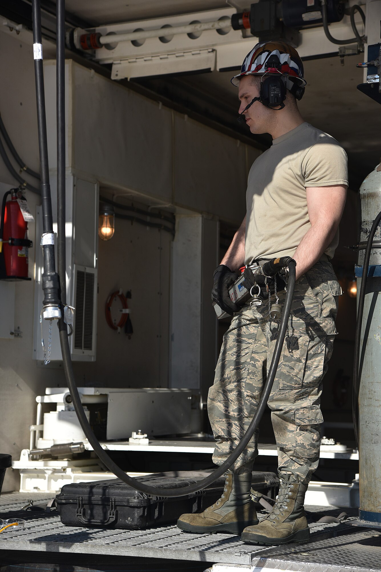 Senior Airman Daniel Valko, 741st Maintenance Squadron mechanical and pneudraulics section technician, lowers a hoist from a payload transporter March 18, 2019, at Malmstrom Air Force Base, Mont.
