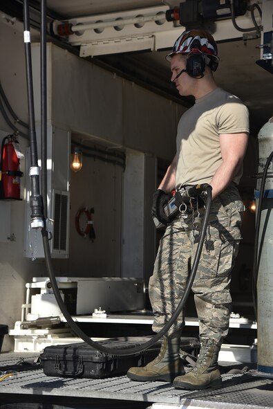 Senior Airman Daniel Valko, 741st Maintenance Squadron mechanical and pneudraulics section technician, lowers a hoist from a payload transporter March 18, 2019, at Malmstrom Air Force Base, Mont.