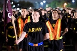 Soldiers assigned to the Health Readiness Center of Excellence stand at ease in formation prior to the pre-dawn 2019 Viva Fiesta Fun Run at Joint Base San Antonio-Fort Sam Houston April 5.