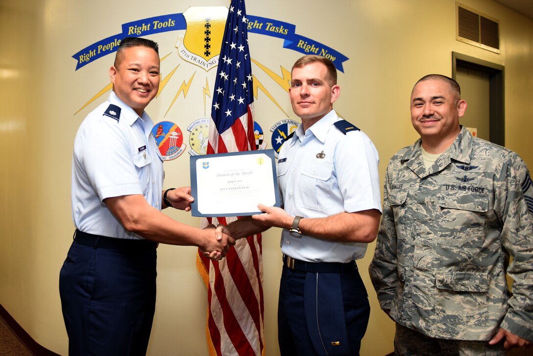 U.S. Air Force Lt. Col. Abraham Salomon, 17th Training Group vice commander, presents the 315th Training Squadron Student of the Month award to 2nd Lt. Nathan Neal, 315th TRS student, at the Brandenburg Hall on Goodfellow Air Force Base, Texas, April 5, 2019. The 315th TRS’s vision is to develop combat-ready intelligence, surveillance and reconnaissance professionals and promote an innovative squadron culture and identity unmatched across the U.S. Air Force. (U.S. Air Force photo by Senior Airman Seraiah Hines/Released)