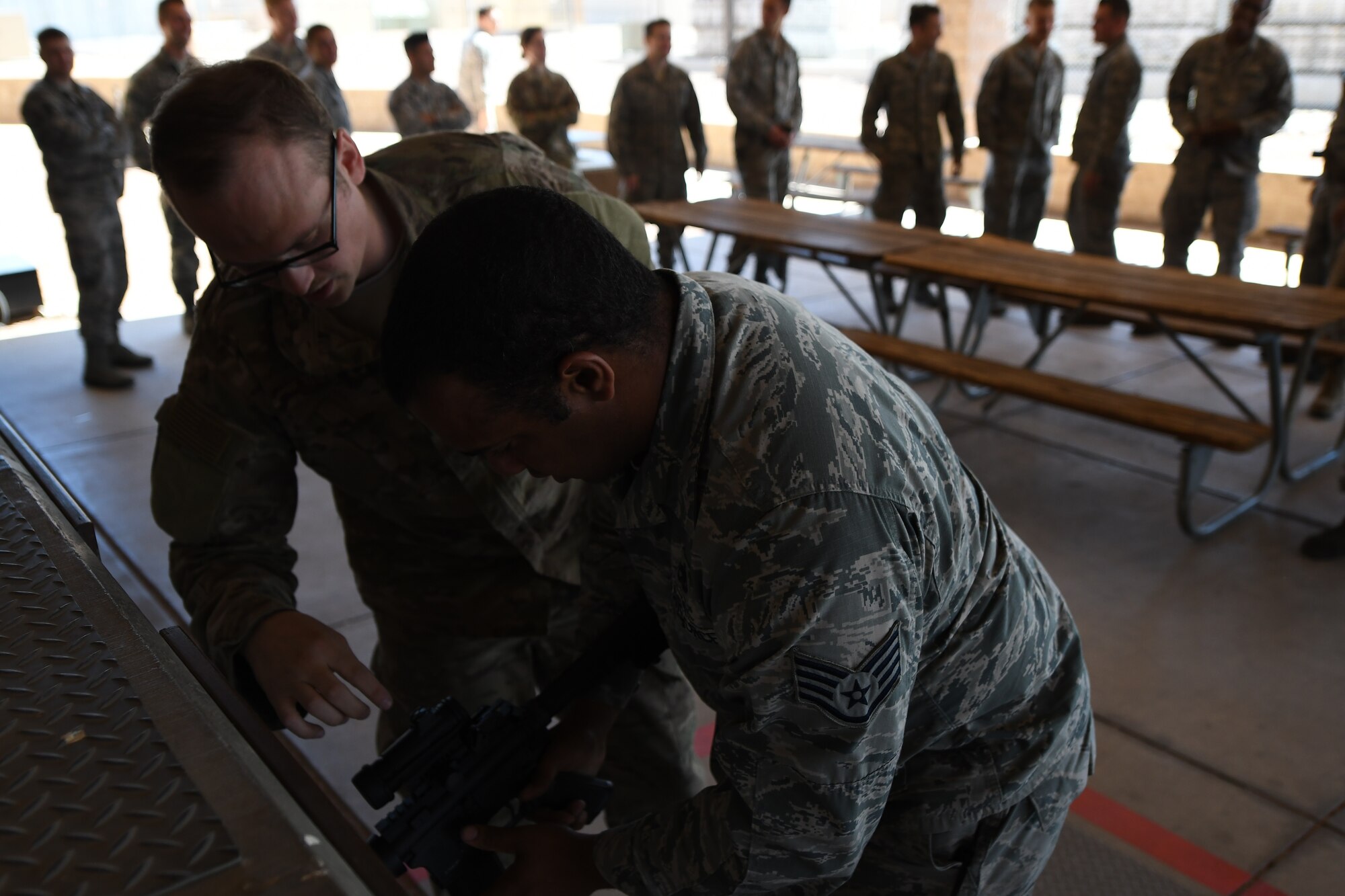 A photo of airmen cleaning an M-4