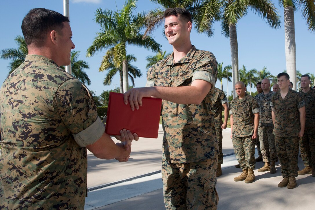 Sgt. Maxwell Crews receives his promotion warrant during his promotion ceremony at U.S. Southern Command, Doral, Fla., April 1, 2019.