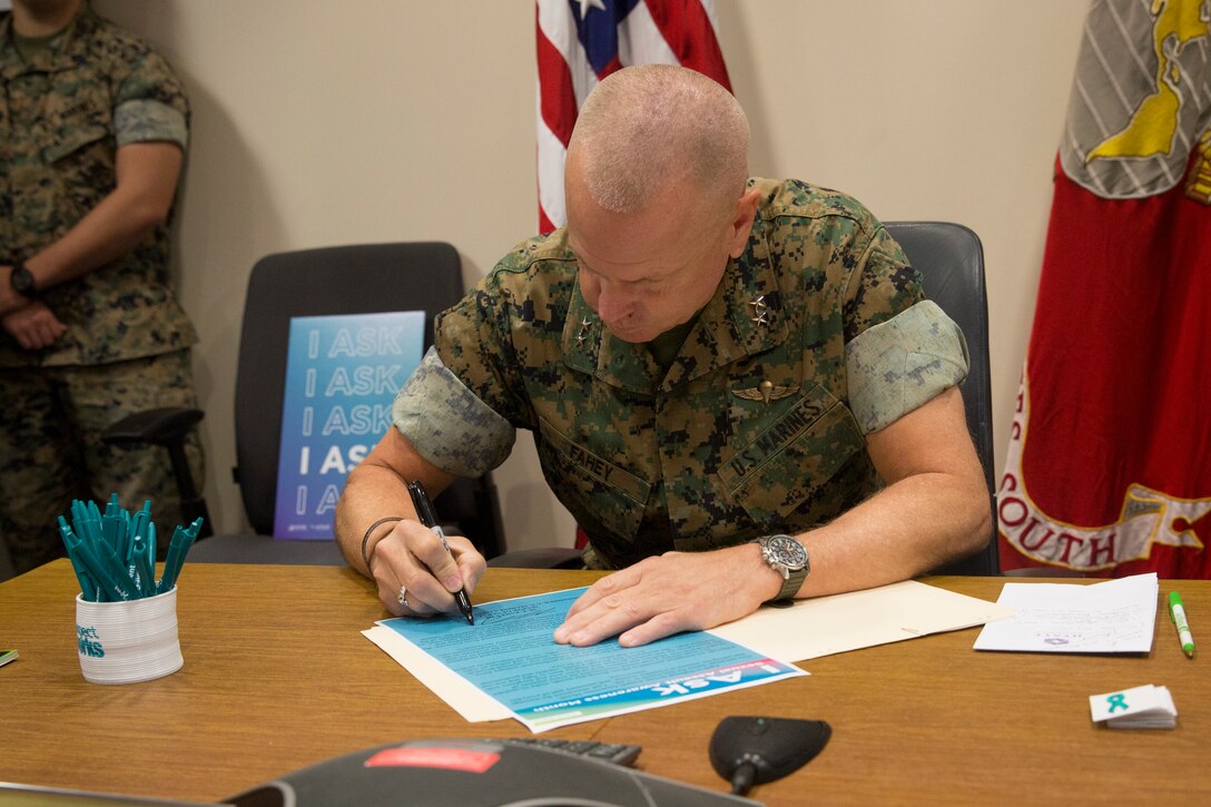 Maj. Gen. Michael F. Fahey III signs a proclamation for sexual assault awareness month at U.S. Marine Corps Forces, South, Doral, Fla., April 2, 2019.