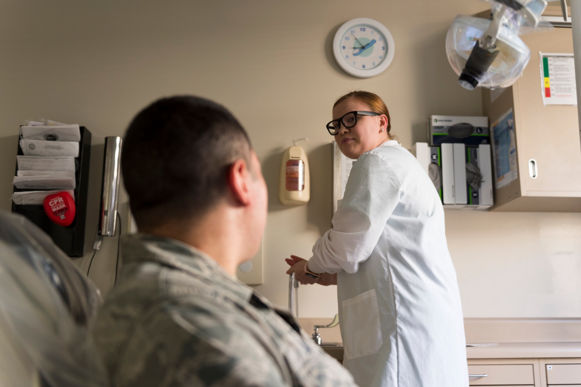 Airman 1st Class Katherine Foster, 23d Aerospace Medicine Squadron dental assistant, right, talks to Senior Airman Gabriel Jimenez, 23d Aerospace Medicine Squadron public health technician, left, during 'Deployers 1st' Thursday, April 4, 2019, at Moody Air Force Base, Ga. 'Deployers 1st' Thursdays is a program that prioritizes giving deploying Airmen medical clearance faster. (U.S. Air Force photo by Airman 1st Class Hayden Legg)