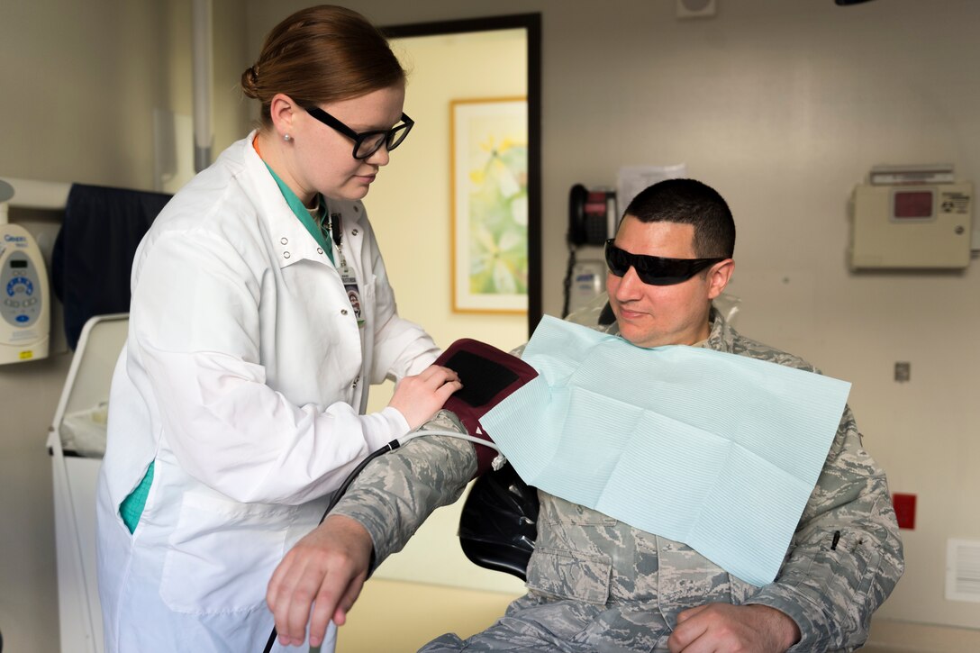 Airman 1st Class Katherine Foster, 23d Aerospace Medicine Squadron dental assistant, left, checks the blood pressure of Senior Airman Gabriel Jimenez, 23d Aerospace Medicine Squadron public health technician, right, during 'Deployers 1st' Thursday, April 4, 2019, at Moody Air Force Base, Ga. 'Deployers 1st' Thursdays is a program that prioritizes giving deploying Airmen medical clearance faster. (U.S. Air Force photo by Airman 1st Class Hayden Legg)