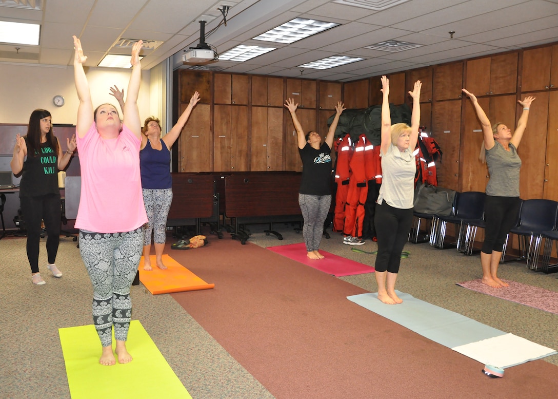 Savannah District Realty Specialist and Certified Yoga Instructor Emily Jimmo, instructs district team members during yoga class. Jimmo voluntarily teaches the class once a week, during lunch, to help promote a healthy, less stressful work atmosphere.