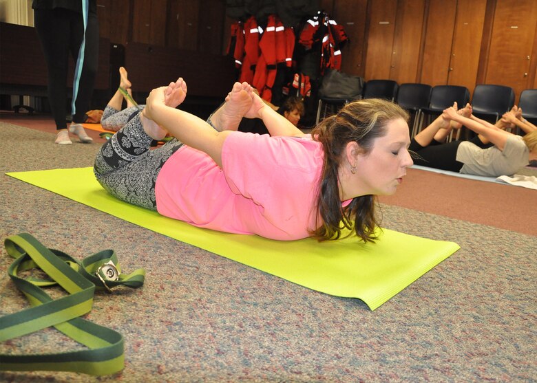 Helpdesk IT Specialist Dawn Ratner performs a yoga bow pose. Ratner is one of 24 Savannah District employees who participate in the class during lunch.