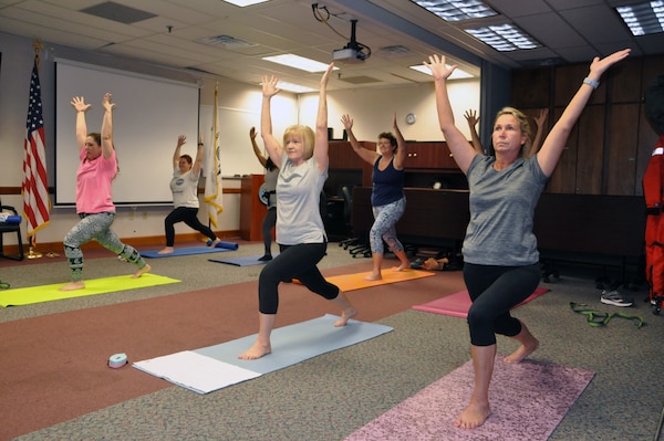 Helpdesk IT Specialist Dawn Ratner performs a yoga bow pose. Ratner is one of 24 Savannah District employees who participate in the class during lunch.