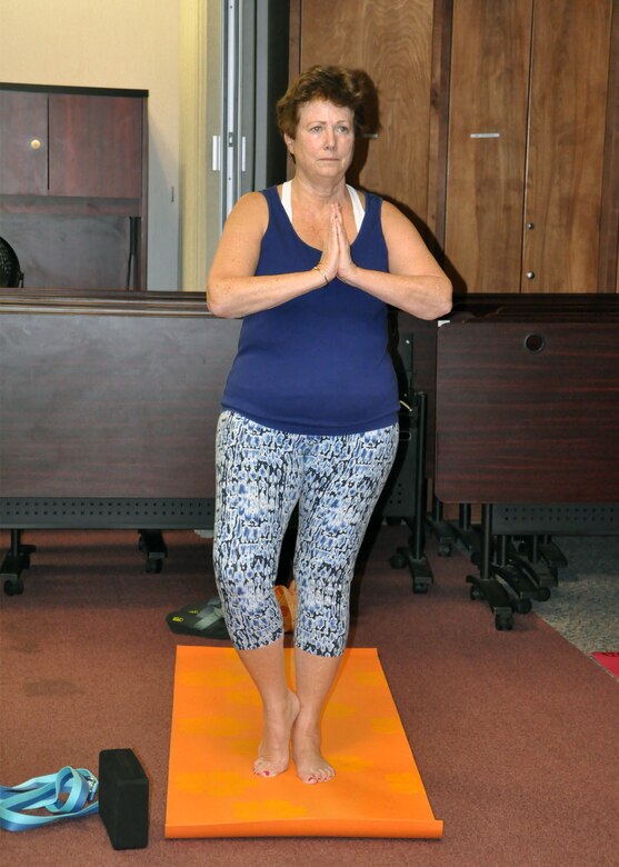 Dorothy Steinbeiser, a senior realty specialist, with the Savannah District stands in a tree pose during yoga class. The class, taught by Savannah District employee Emily Jimmo, focuses on various poses, meditation, and self-care.