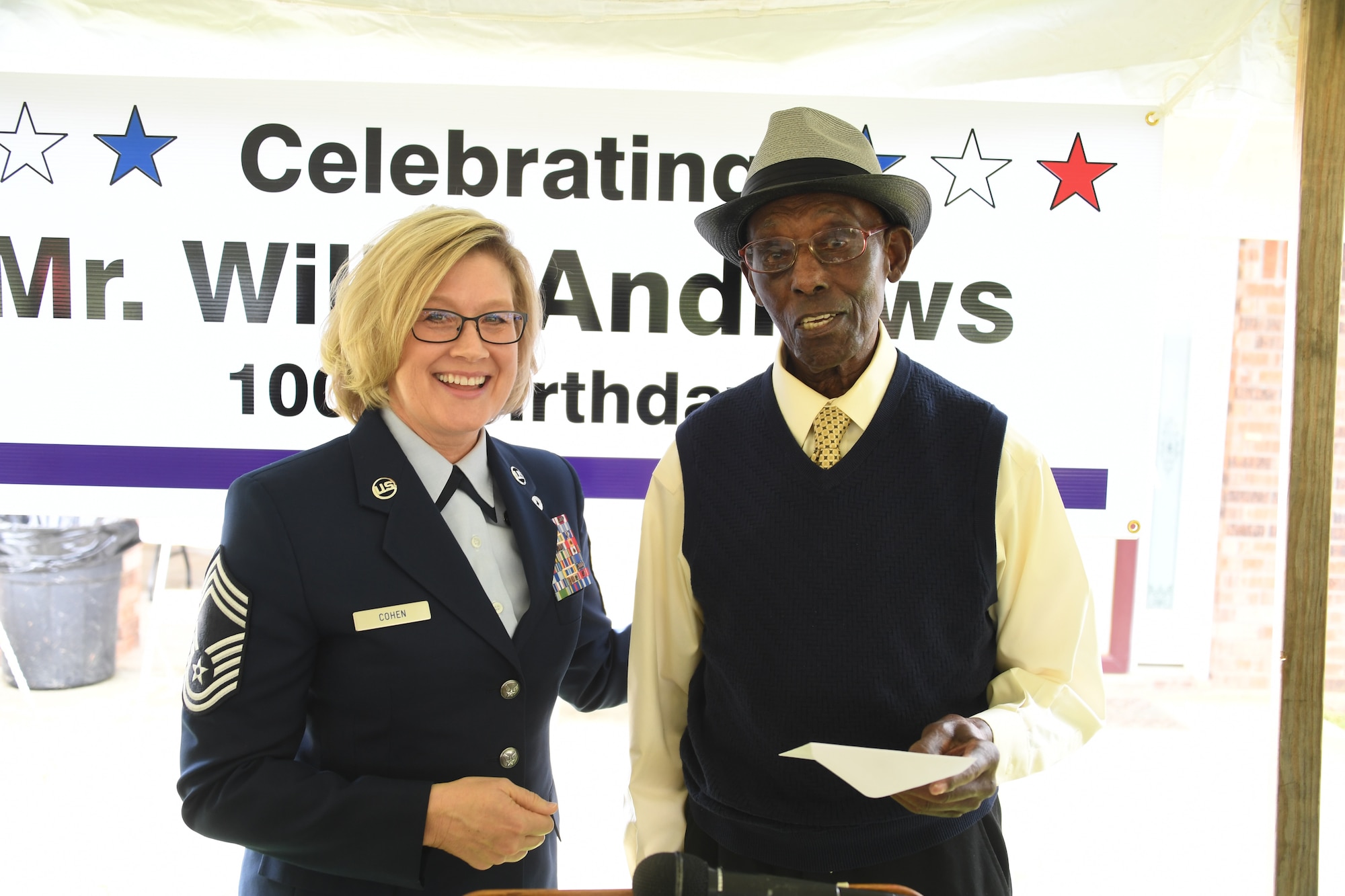Willis Andrews, former aviation engineer under Eighth Air Force and World War II veteran, is presented two Eighth Air Force coins and a letter of appreciation by Chief Master Sgt. Shelley Cohen, 8th Air Force command chief IMA, during his 100th birthday celebration in Truxno, La., March 30, 2019. Andrews spent three years overseas during World War II serving in France, Germany and England. (U.S. Air Force photo by Senior Airman Luke Hill)