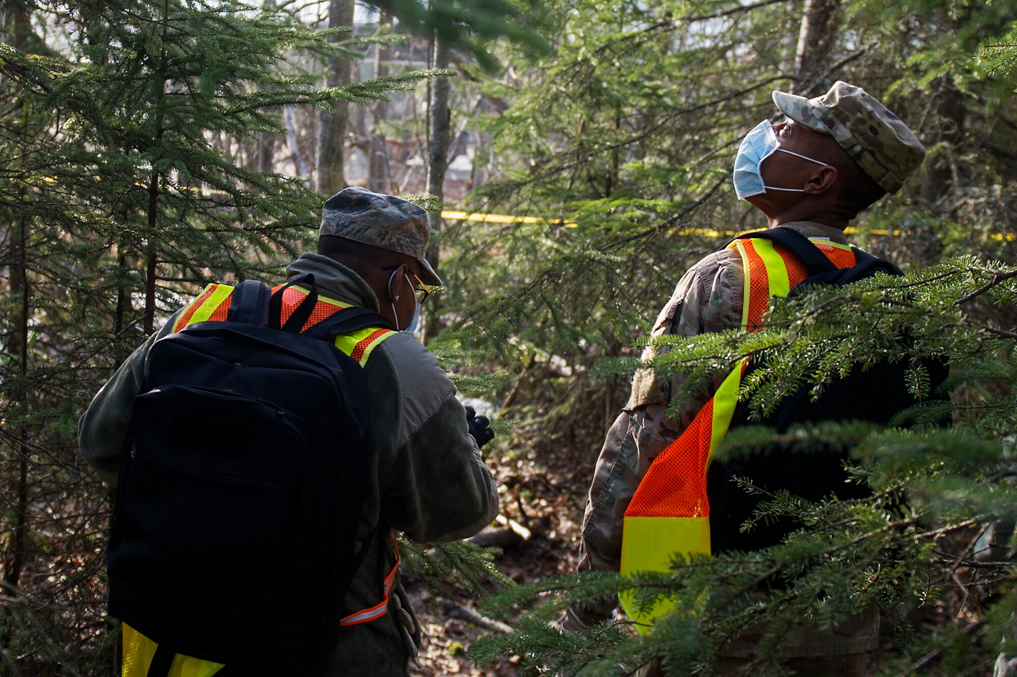 U.S. Air Force Senior Airman Jeremy Bennett with the 673d Force Support Squadron scans the trees during a search and recovery mission for mortuary affairs training during Polar Force 19-4 at Joint Base Elmendorf-Richardson, Alaska, April 2, 2019. Polar Force is a two-week exercise designed to test JBER’s mission readiness, and strengthen and develop the skills service members require when facing adverse situations.