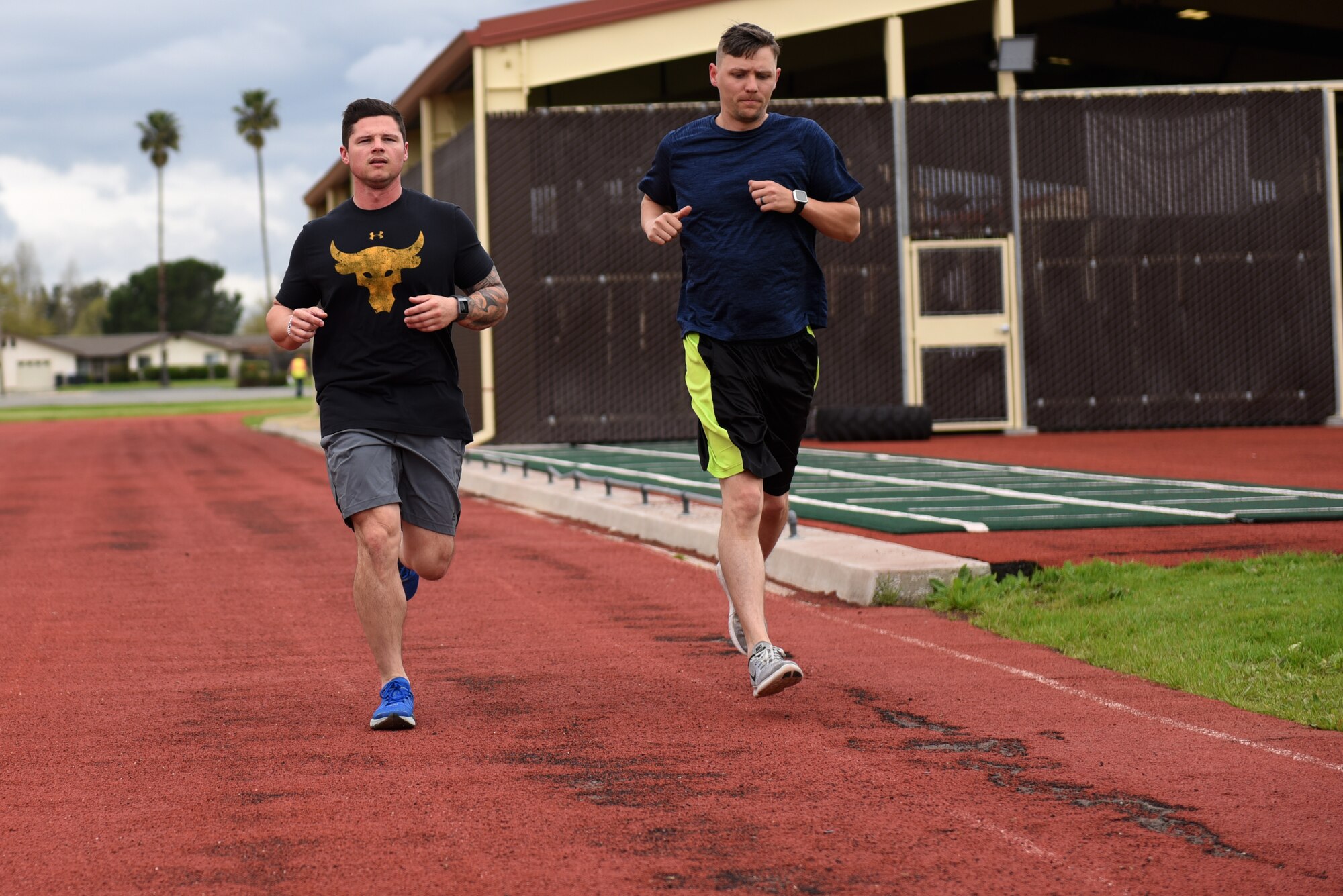 U.S. Air Force Master Sgt. Ryan Chatterley, 312th Airlift Squadron loadmaster, and U.S. Air Force Tech. Sgt. Marshall Freitas, 312th AS flight engineer, run on the red track to prepare for an upcoming PT test April 3, 2019, at Travis Air Force Base, California. Both red and blue tracks are scheduled to undergo renovations April 15 through Aug. 12. (U.S. Air Force photo by Airman 1st Class Cameron Otte)