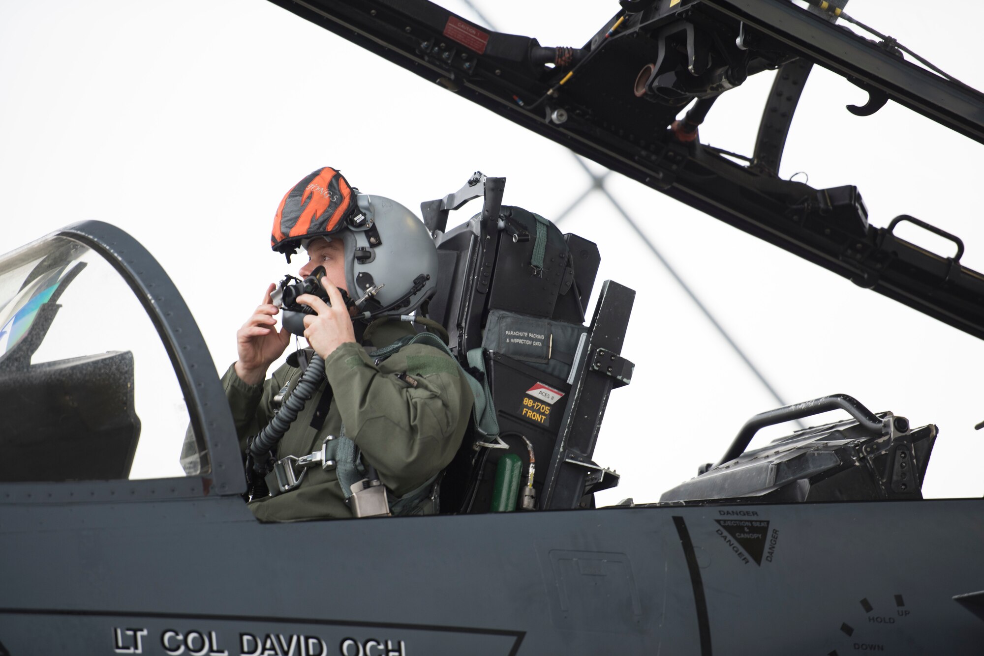 Image of Lt. Col. Thomas Bean, 366th Fighter Wing Inspector General and F-15E instructor pilot, adjusts his helmet before a flight April 3, 2019, at Mountain Home Air Force Base, Idaho. Before flying pilots spend hours mission planning. (U.S. Air Force photo by Senior Airman Alaysia Berry)