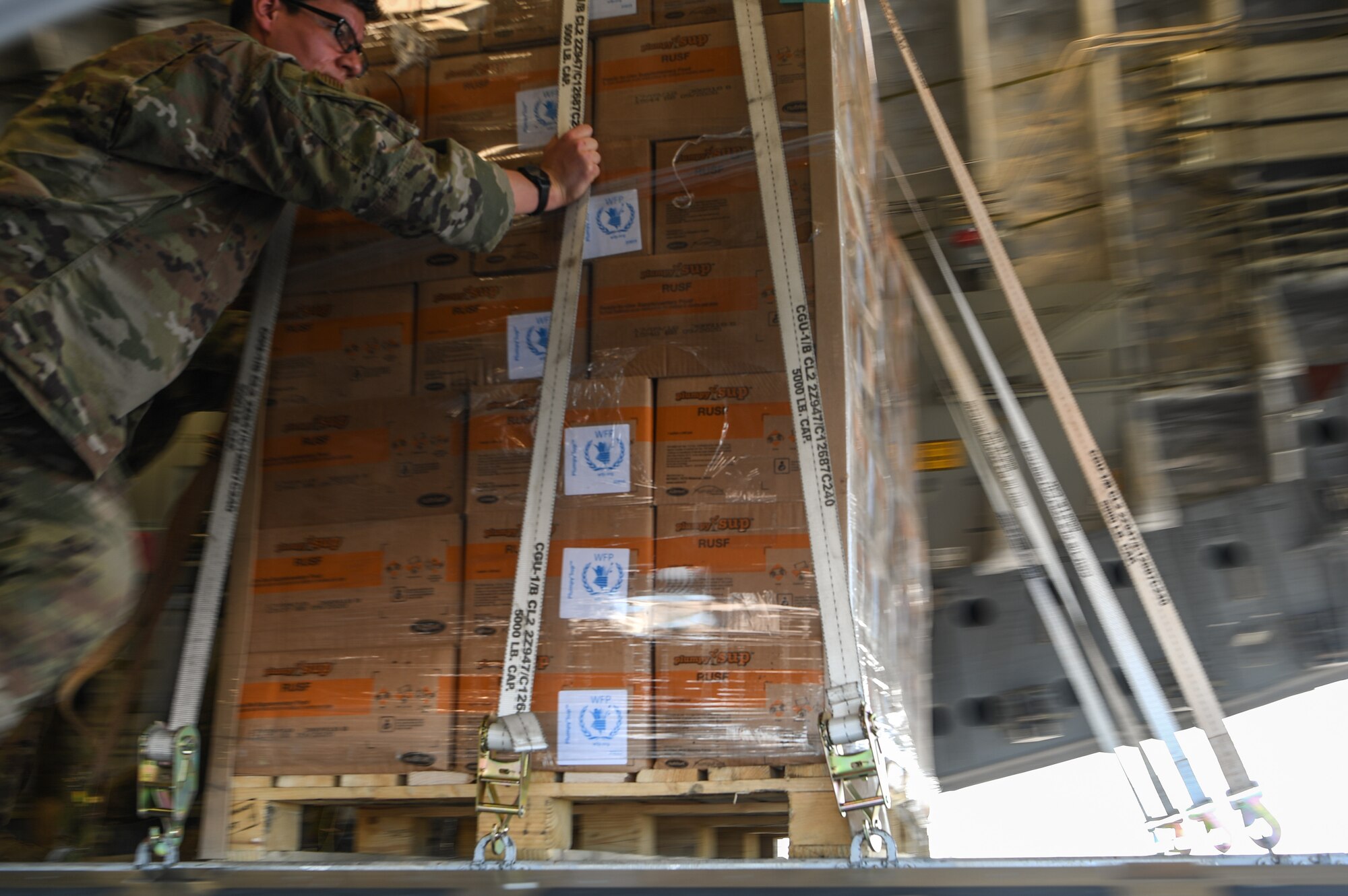 U.S. Airmen assigned to the 435th Contingency Response Group, Ramstein Air Base, Germany, supporting Combined Joint Task Force-Horn of Africa (CJTF-HOA), unload World Food Programme (WFP) relief supplies from a C-17 Globemaster III at Beira Airport, Mozambique, April 2, 2019, during the U.S. Department of Defense’s (DoD) relief effort in the Republic of Mozambique and surrounding areas following Cyclone Idai. Teams from CJTF-HOA, which is leading DoD support to relief efforts in Mozambique, began immediate preparation to respond following a call for assistance from the U.S. Agency for International Development’s Disaster Assistance Response Team. (U.S. Air Force photo by Staff Sgt. Corban Lundborg)