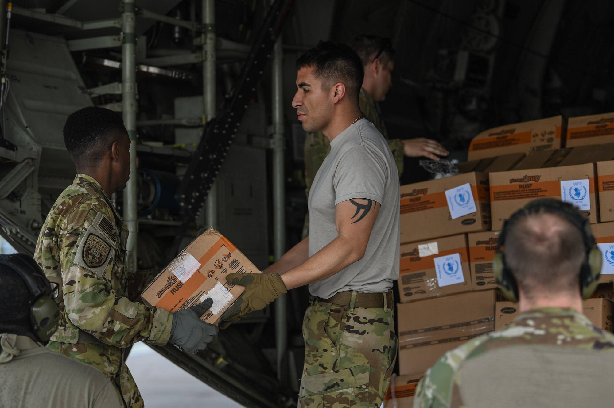 U.S. Airmen assigned to the 75th Expeditionary Airlift Squadron, Combined Joint Task Force-Horn of Africa (CJTF-HOA), offload humanitarian aid from a C-130J Hercules at Beira Airport, Mozambique, April 2, 2019, for the U.S. Department of Defense’s (DoD) relief effort in the Republic of Mozambique and surrounding areas following Cyclone Idai. Teams from CJTF-HOA, which is leading DoD support to relief efforts in Mozambique, began immediate preparation to respond following a call for assistance from the U.S. Agency for International Development’s Disaster Assistance Response Team. (U.S. Air Force photo by Staff Sgt. Corban Lundborg)
