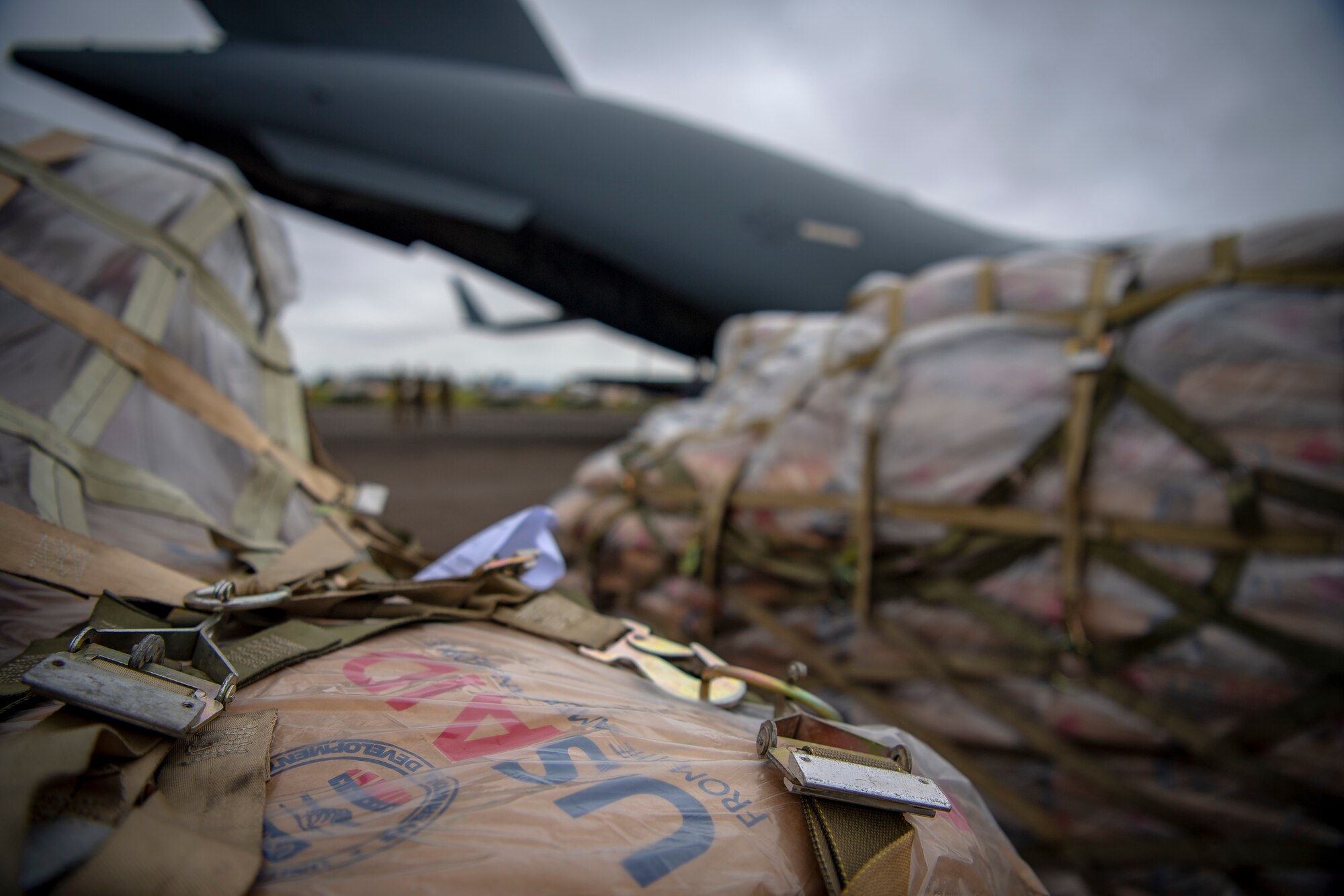 A U.S. Air Force C-17 Globemaster III assigned to Joint Base Lewis-McChord, Washington, supporting Combined Joint Task Force-Horn of Africa, delivers food aid from the United States Agency for International Development (USAID) in Maputo, Mozambique, April 2, 2019. The task force is helping meet requirements identified by USAID assessment teams and humanitarian organizations working in the region by providing logistics support and manpower to USAID at the request of the Government of the Republic of Mozambique. (U.S. Air Force Photo by Tech. Sgt. Chris Hibben)