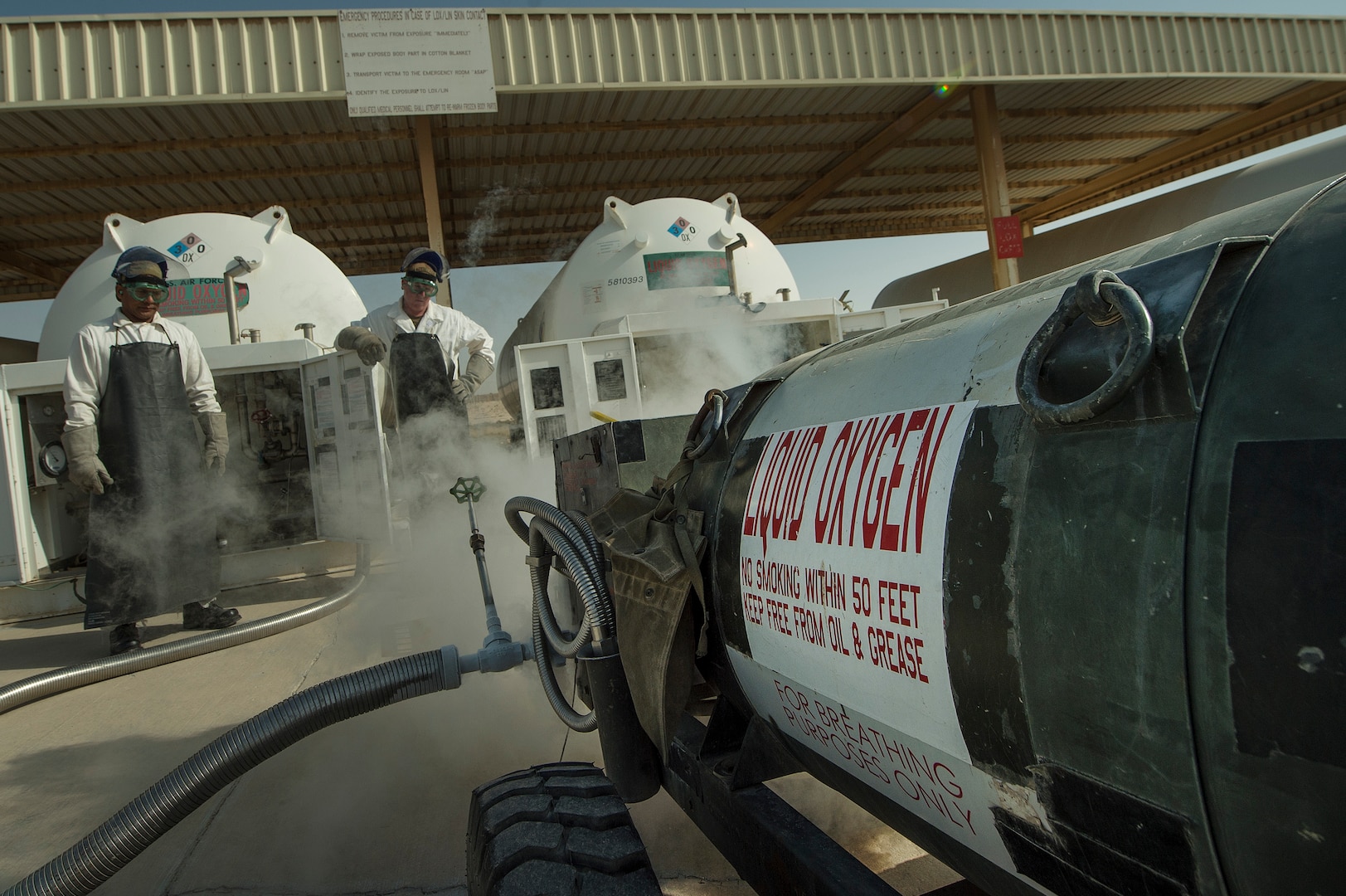 Staff Sgt. Shakir Alikhan, left, 379th Expeditionary Logistics Readiness Squadron (ELRS) cryogenics section fuels journeyman, and Tech. Sgt. Nathan Retallack, right, 379th ELRS fuels cryogenic supervisor, prepare to retrieve and inspect liquid oxygen at Al Udeid Air Base, Qatar, April 4, 2019. The cryogenics team ensures aircrew members across U.S. Central Command are equipped with liquid oxygen and nitrogen, supporting flying missions across the region. (U.S. Air Force photo by Tech. Sgt. Christopher Hubenthal)