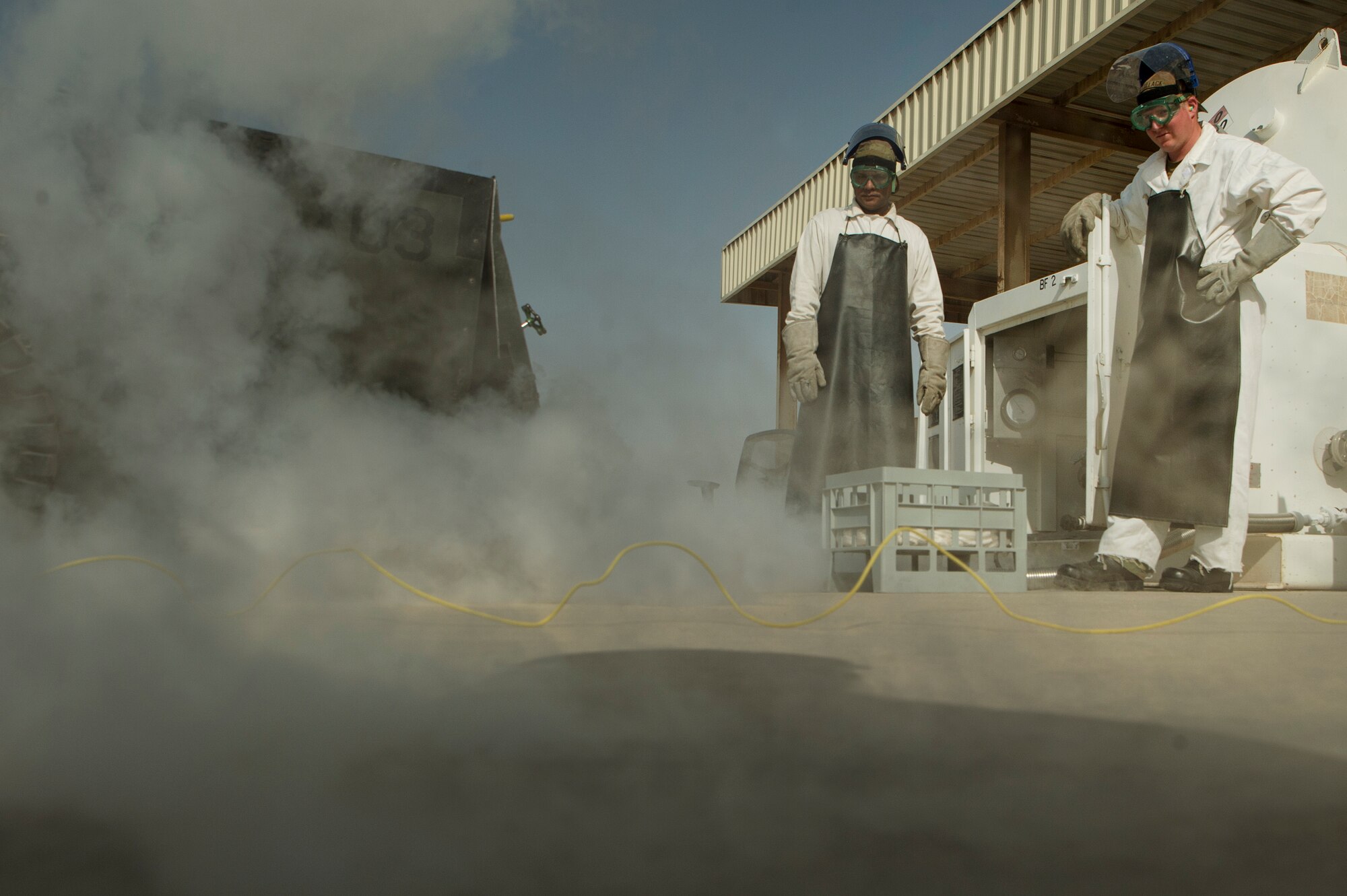 Staff Sgt. Shakir Alikhan, left, 379th Expeditionary Logistics Readiness Squadron (ELRS) cryogenics section fuels journeyman, and Tech. Sgt. Nathan Retallack, right, 379th ELRS fuels cryogenic supervisor, prepare to retrieve and inspect liquid oxygen at Al Udeid Air Base, Qatar, April 4, 2019. The cryogenics team here ensures aircrew members across U.S. Central Command are equipped with liquid oxygen and nitrogen, supporting flying missions across the region. (U.S. Air Force photo by Tech. Sgt. Christopher Hubenthal)