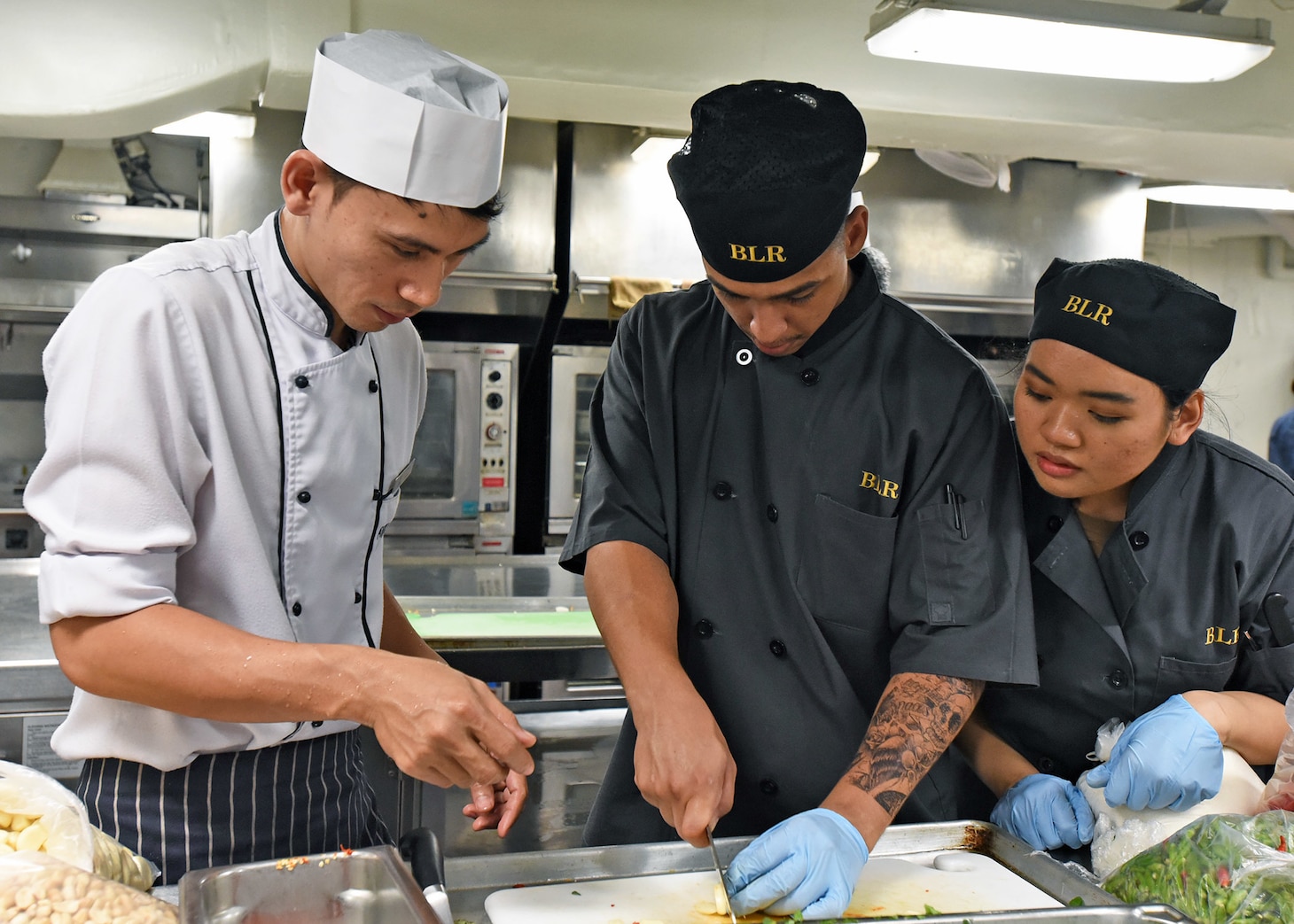 LAEM CHABANG, Thailand (April 6, 2019) - Culinary Specialist Seaman Ahmod Phillips, from Las Vegas, and Culinary Specialist Seaman Cassie Tabladillo, from Oahu, Hawaii, receive food preparation training from Avani Hotel Pattaya soux-chef Watchara Plangsorn during a traditional Thai cooking event aboard U.S. 7th Fleet Flagship USS Blue Ridge (LCC 19). Blue Ridge is the oldest operational ship in the Navy and, as 7th Fleet command ship, actively works to foster relationships with allies and partners in the Indo-Pacific Region.