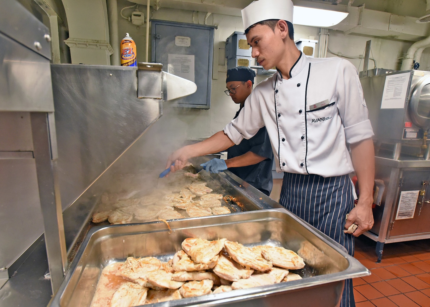 LAEM CHABANG, Thailand (April 6, 2019) - Culinary Specialist 3rd Class Jerico Gonzales, from Glendale, Calif., cooks chicken with Avani Hotel Pattya soux-chef Watchara Plangsorn during a traditional Thai cooking event aboard U.S. 7th Fleet Flagship USS Blue Ridge (LCC 19). Blue Ridge is the oldest operational ship in the Navy and, as 7th Fleet command ship, actively works to foster relationships with allies and partners in the Indo-Pacific Region.