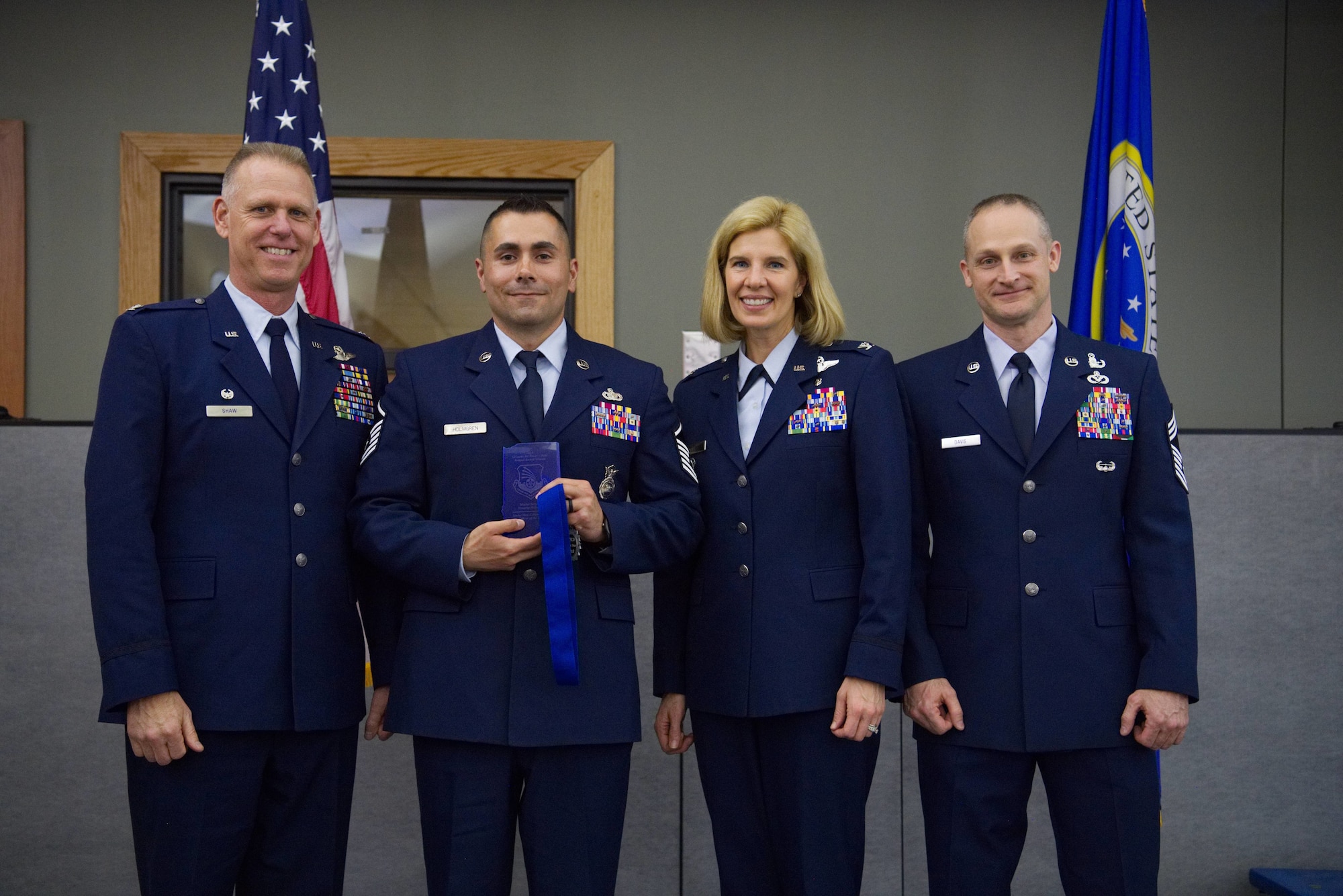 Colonel Larry Shaw, 434th Air Refueling Wing commander, presents Master Sgt. Timothy Holmgren, 434th Mission Support Group unit training program manager, with the Senior Non-commissioned Officer of the Year Award at the Grissom Annual Awards Banquet in the Grissom dining facility, April 4, 2019. Grissom holds the banquet each year to recognize the achievements of outstanding Airmen. (U.S. Air Force photo / Senior Airman Harrison Withrow)