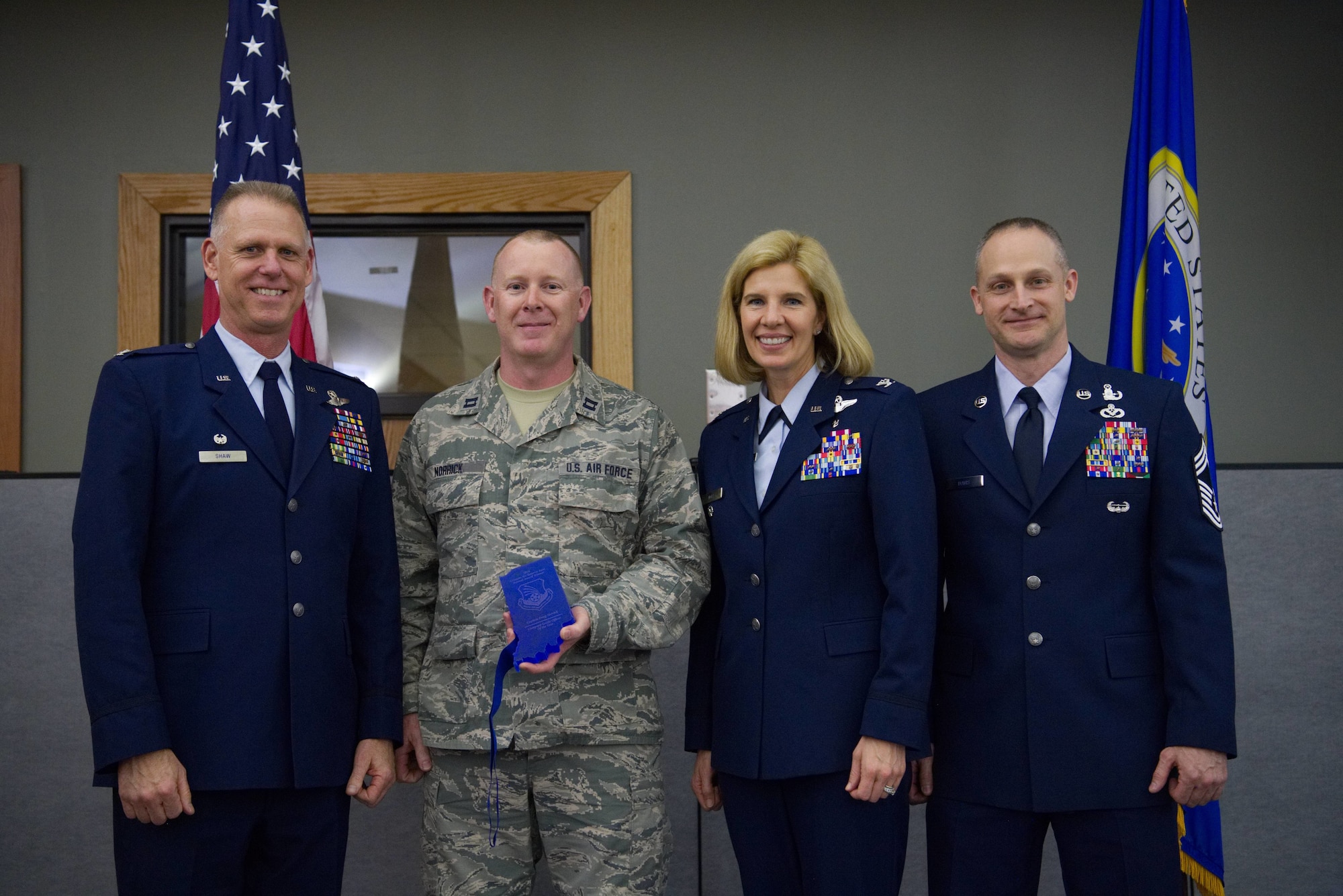 Colonel Larry Shaw, 434th Air Refueling Wing commander, presents Captain Doug Norrick, 434th ARW optometrist, with the Company Grade Officer of the Year Award at the Grissom Annual Awards Banquet in the Grissom dining facility, April 4, 2019. Grissom holds the banquet each year to recognize the achievements of outstanding Airmen. (U.S. Air Force photo / Senior Airman Harrison Withrow)