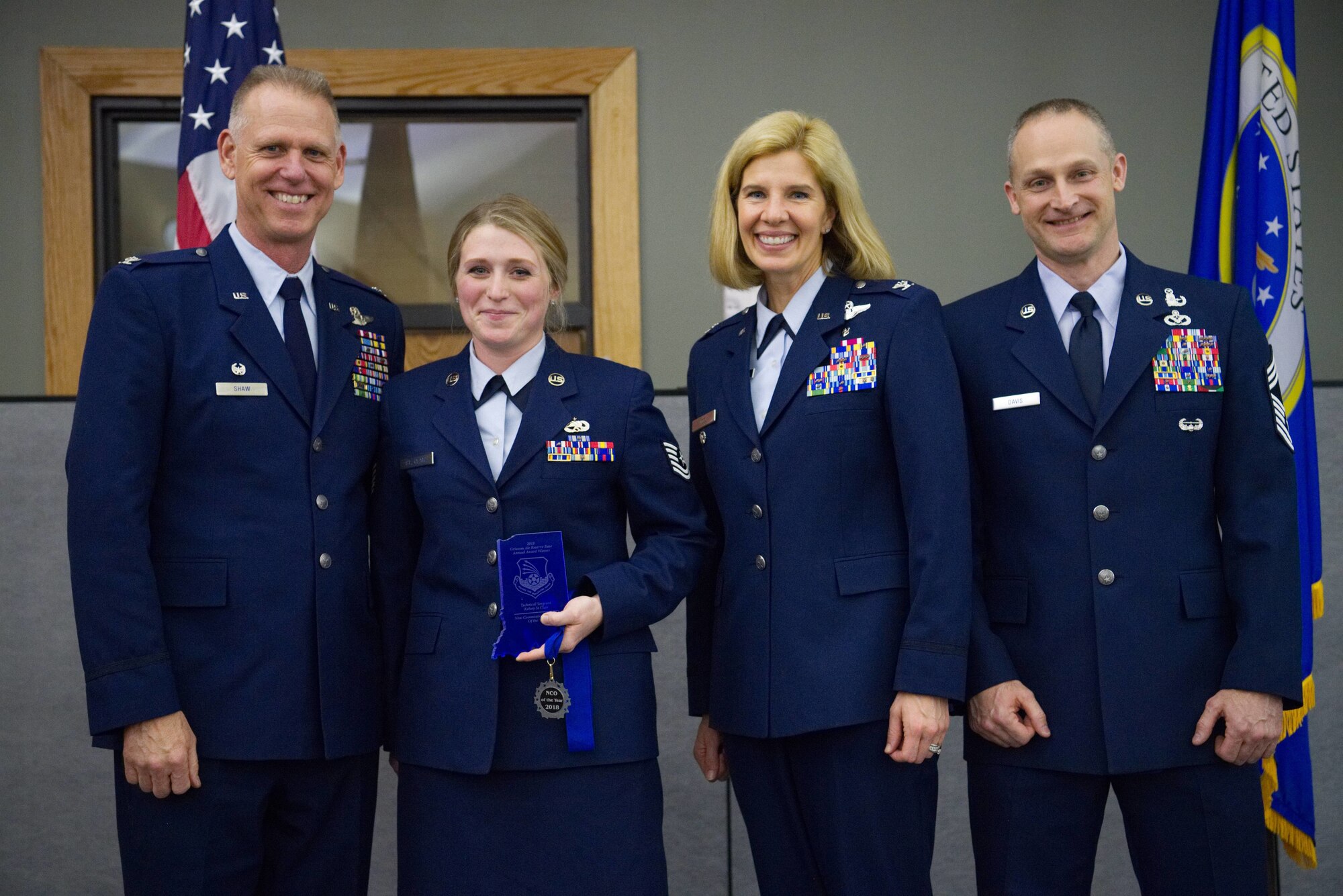 Colonel Larry Shaw, 434th Air Refueling Wing commander, presents Tech. Sgt. Kelsey St. Clair, 434th Maintenance Group maintainer, with the Non-commissioned Officer of the Year Award at the Grissom Annual Awards Banquet in the Grissom dining facility, April 4, 2019. Grissom holds the banquet each year to recognize the achievements of outstanding Airmen. (U.S. Air Force photo / Senior Airman Harrison Withrow)