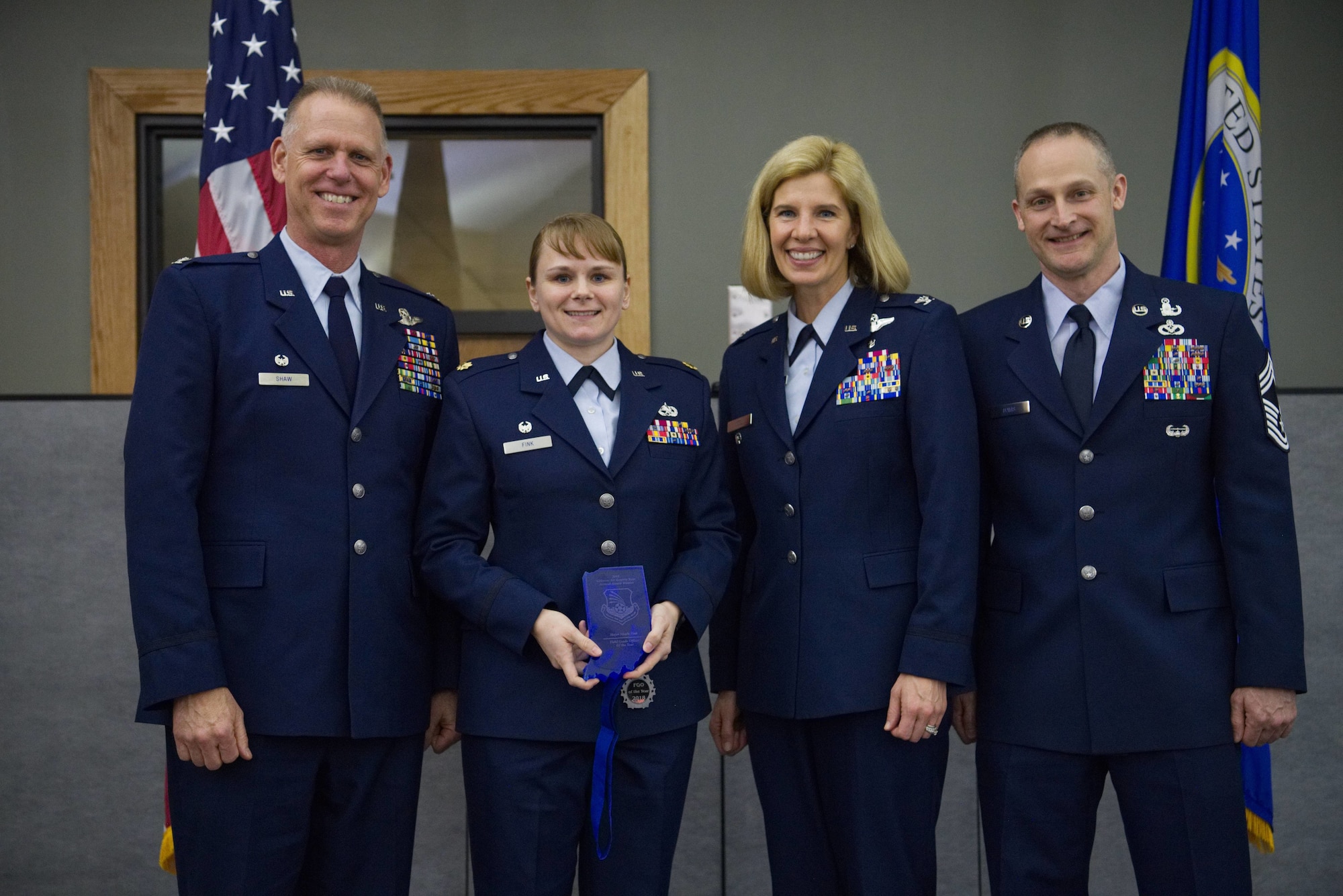Colonel Larry Shaw, 434th Air Refueling Wing commander, presents Maj. Nicole Fink, 434th Maintenance Group commander, with the Field Grade Officer of the Year Award at the Grissom Annual Awards Banquet in the Grissom dining facility, April 4, 2019. Grissom holds the banquet each year to recognize the achievements of outstanding Airmen. (U.S. Air Force photo / Senior Airman Harrison Withrow)