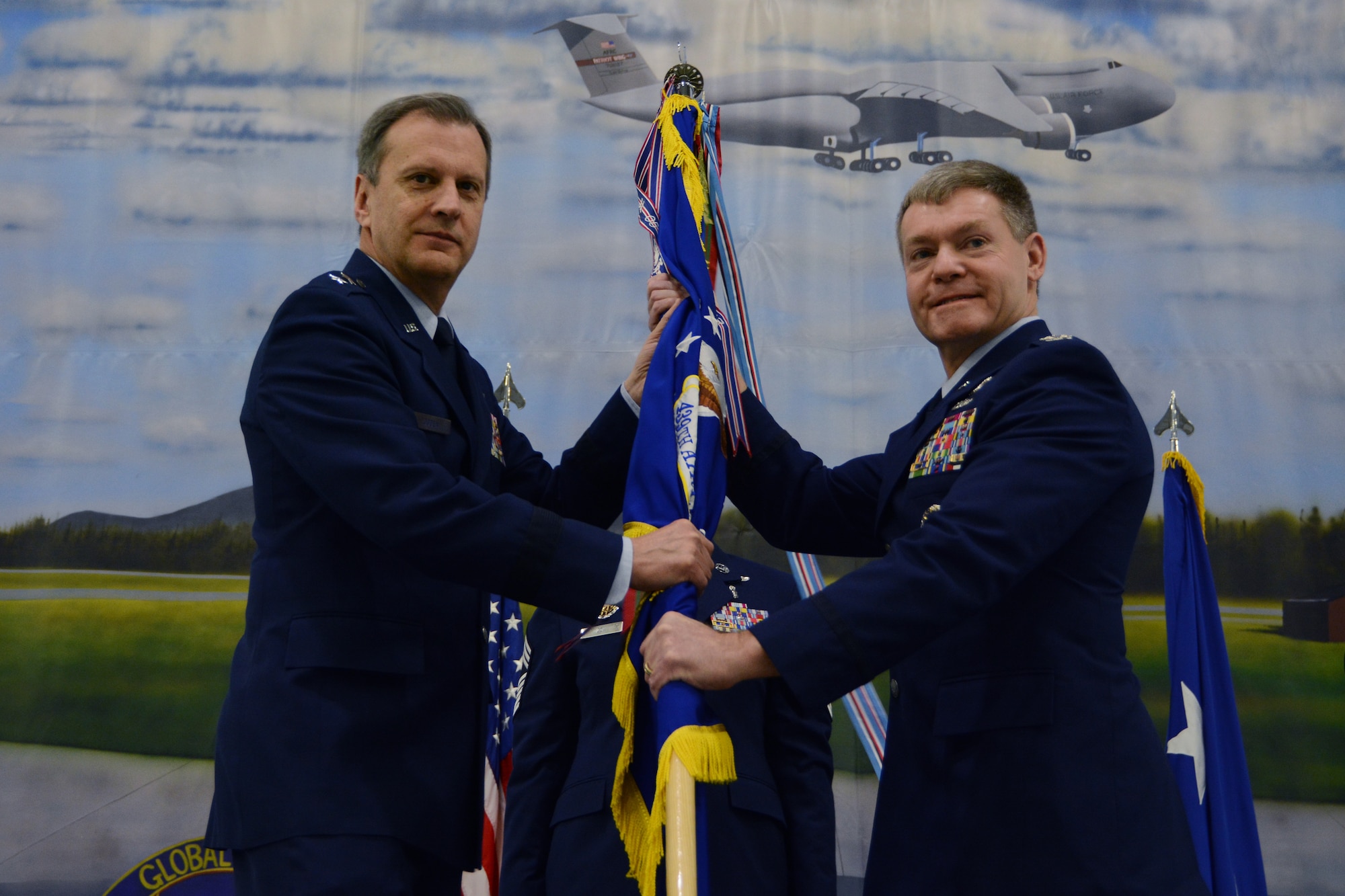 Maj. Gen. Randall A. Ogden, Air Force Reserve Command 4th Air Force commander, passes the 439th Airlift Wing guidon to Col. Craig C. Peters, the new 439th Airlift Wing commander, during a change of command ceremony, April 6, 2019, Westover Air Reserve Base, Mass. Though officially Peters won’t assume command until April 14, the ceremony was held in advance in order to coincide with a Unit Training Assembly, when the majority of reservists are on duty. (U.S. Air Force photo by Senior Airman Hanna Smith/Released)