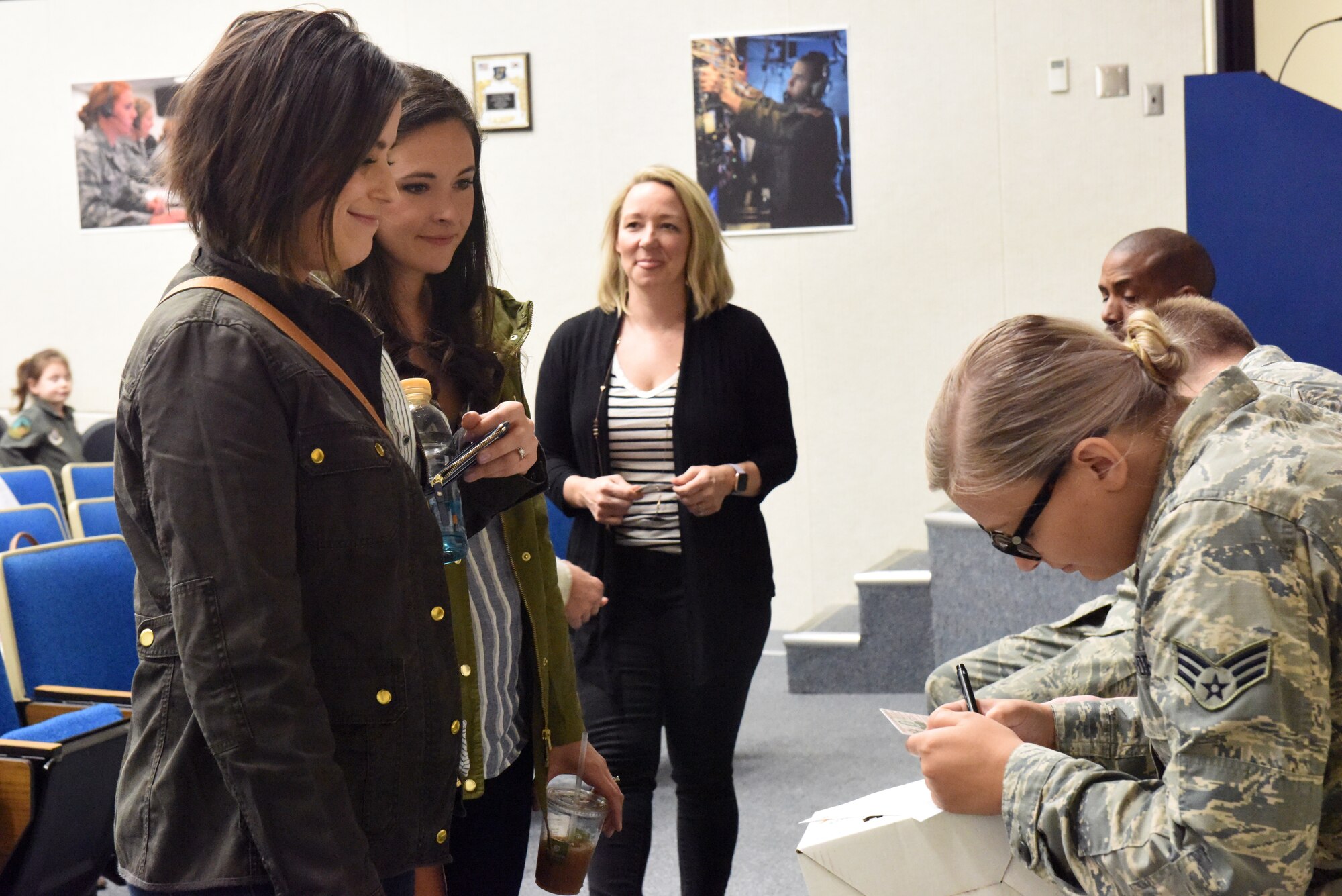 Military spouses affiliated with the 193rd Special Operations Wing, Middletown, Pennsylvania, check in for a spouse orientation flight aboard an EC-130J Super J aircraft April 7, 2019. There were 15 spouses that participated in this orientation flight. (U.S. Air National Guard photo by Staff Sgt. Julia Sorber/Released)