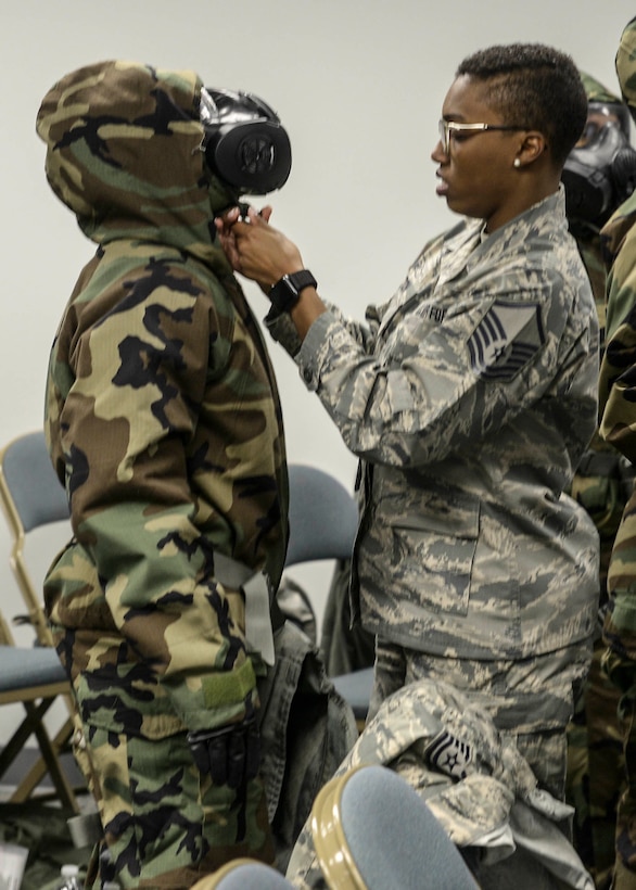 A member of the 913th Airlift Group staff is checked for proper wear of her protective gear during annual chemical, biological, radiological and nuclear defense training at Little Rock Air Force Base, Arkansas, April 6, 2019.