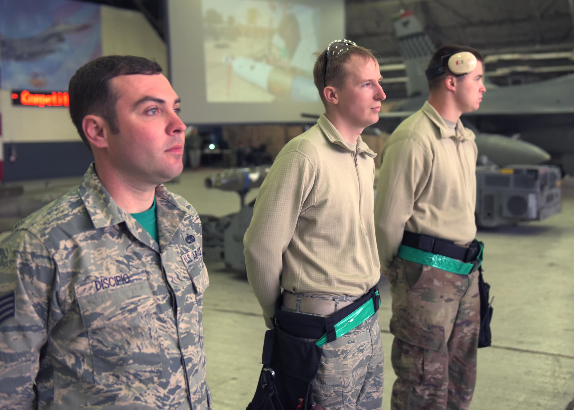 U.S. Air Force Staff Sgt. Peter Discipio, a weapons load crew team chief, Airman 1st Class Michael Smith and Senior Airman Dylan Raines, weapons load crew team members all assigned to the 51st Aircraft Maintenance Squadron,  prepare to begin a weapons load crew competition at Osan Air Base, Republic of Korea, April 5, 2019. Weapons load crew competitions test a squadron’s ability to safely and accurately load munitions onto their respective aircraft. (U.S. Air Force Photo by Staff Sgt. Timothy Dischinat)