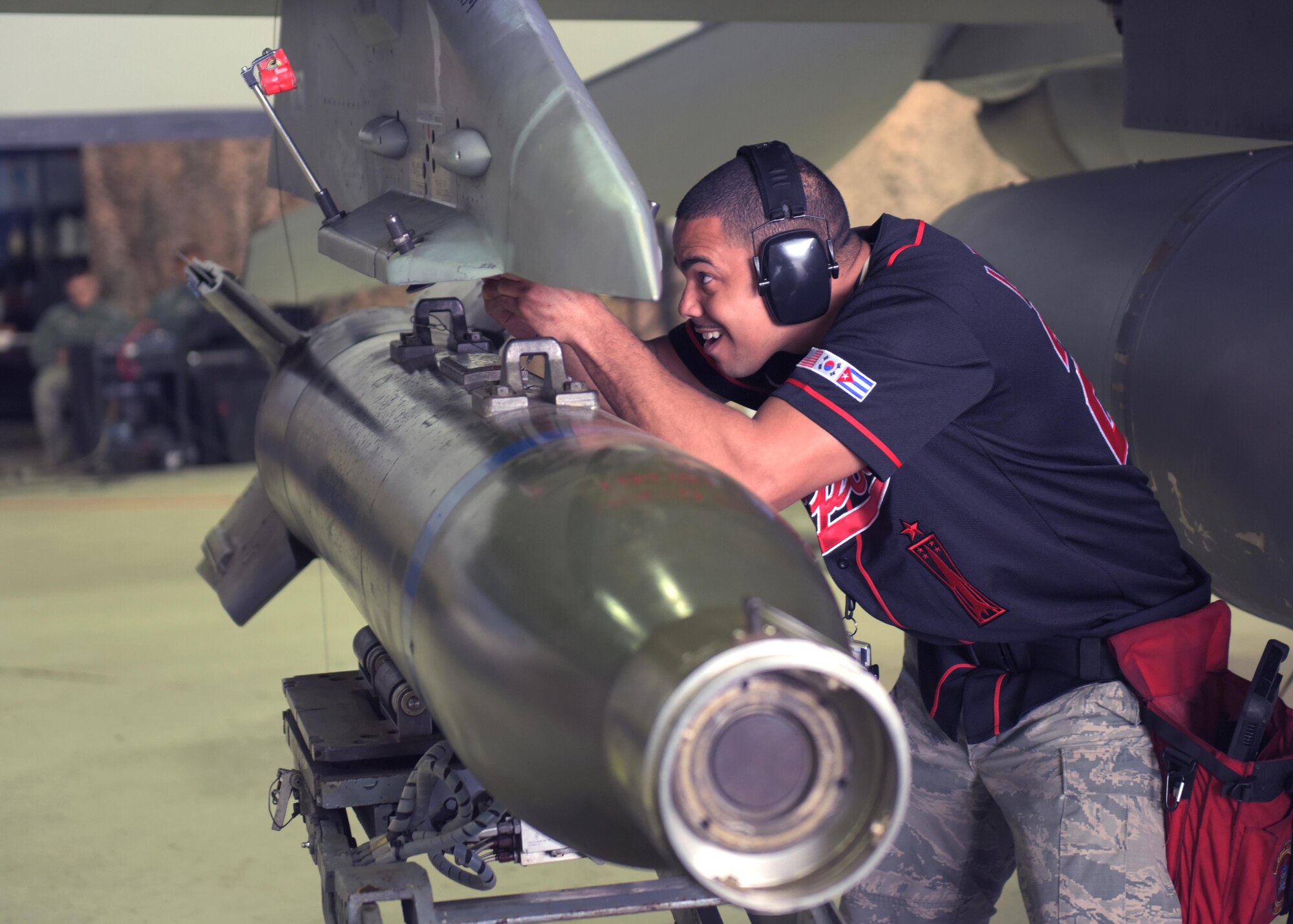 U.S. Air Force Staff Sgt. Marcel Leduff, a weapons load crew team chief assigned to the 51st Aircraft Maintenance Squadron, mounts an armament onto an F-16 Fighting Falcon during a weapons load crew competition at Osan Air Base, Republic of Korea, April 5, 2019. Weapons load crew competitions test a squadron’s ability to safely and accurately load munitions onto their respective aircraft. (U.S. Air Force Photo by Staff Sgt. Timothy Dischinat)