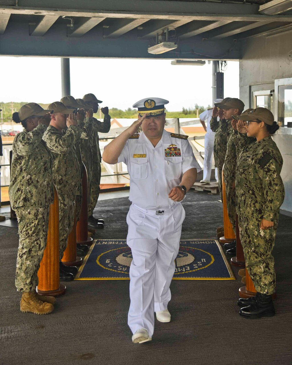 Vice Adm. Tatsuhiko Takashima, Commander, Fleet Submarine Forces for Japanese Maritime Self-Defense Force,
arrives at the quarterdeck of the submarine tender USS Emory S. Land (AS 39) for a scheduled tour. During his visit to Guam, Takashima viewed ships, facilities and sites on island including ship repair, quality-of-life facilities for submariners and partnership opportunities in the region.