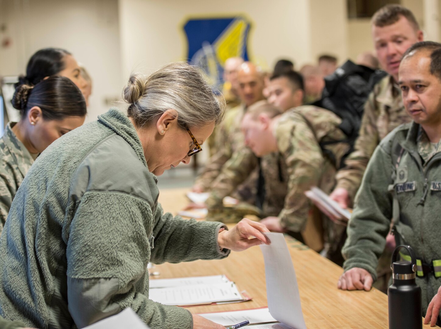 Tech. Sgt. Karen Peterson, noncommissioned officer in charge of command support staff with the Alaska Air National Guard’s 176th Logistics Readiness Squadron, checks the paperwork of a deployer as part of the Polar Force 19 exercise on Joint Base Elmendorf-Richardson, April 2, 2019.