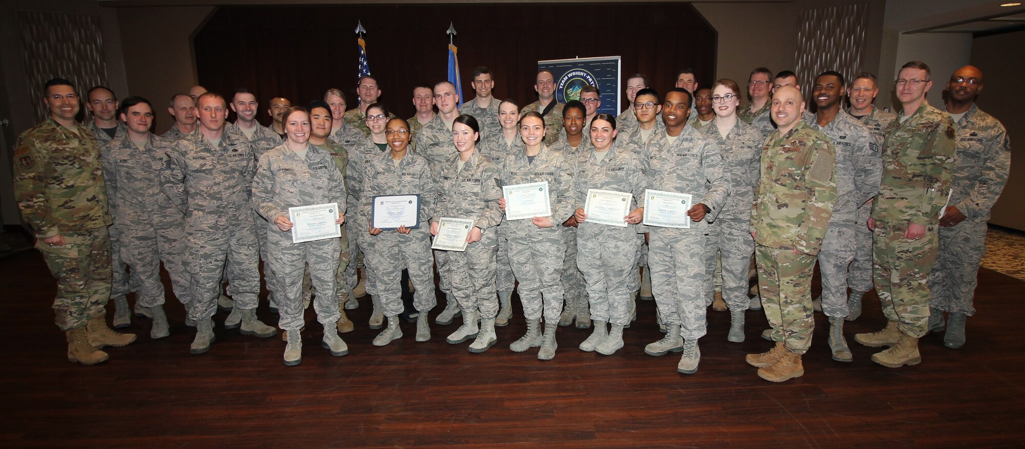 Col. Tom Sherman, 88th Air Base Wing and installation commander, (left), and Chief Master Sgt. Stephen Arbona, 88th Air Base Wing command chief (right), celebrated the newest Team Wright-Patt enlisted promotees during a ceremony at the Wright-Patterson Air Force Base Club and Banquet Center, Mar. 29, 2019. (U.S. Air Force Photo/Thomas Lewis)