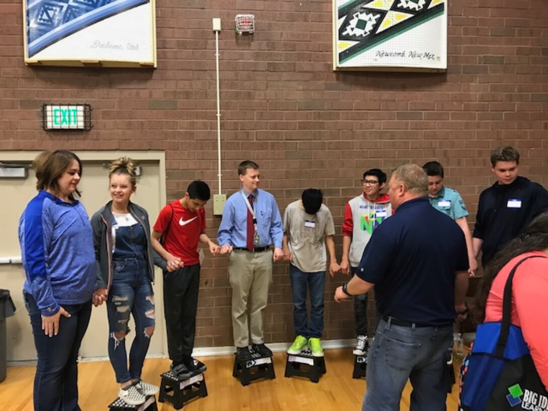 Hill Air Force Base electrical engineer Sebron Farmer conducts an electricity demonstration with students at Monument Valley High School in Kayenta, Utah, during the San Juan Career Fair March 27, 2019. Hill AFB computer scientists and engineers presented the electricity demonstration, taught some basic coding skills and encouraged students to focus on STEM-related subjects, giving them an idea of the important work they could do if they chose an Air Force career. (Courtesy photo)