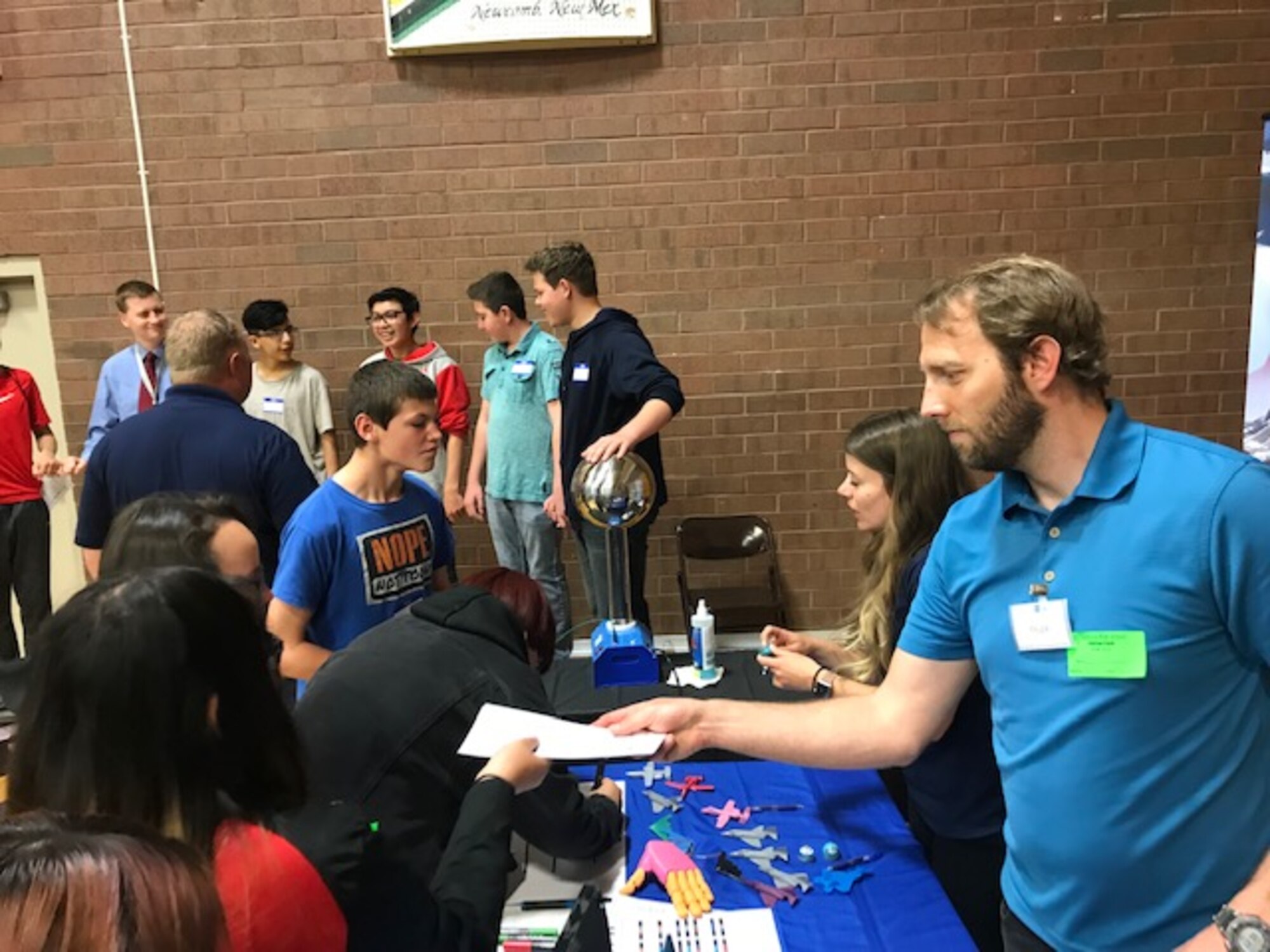 Students at Monument Valley High School in Kayenta, Utah, talk with Hill Air Force Base electrical engineer Kristen Keyes and computer scientist Tyler Shilling during the San Juan Career Fair March 27, 2019. Hill AFB computer scientists and engineers presented the electricity demonstration, taught some basic coding skills and encouraged students to focus on STEM-related subjects, giving them an idea of the important work they could do if they chose an Air Force career. (Courtesy photo)