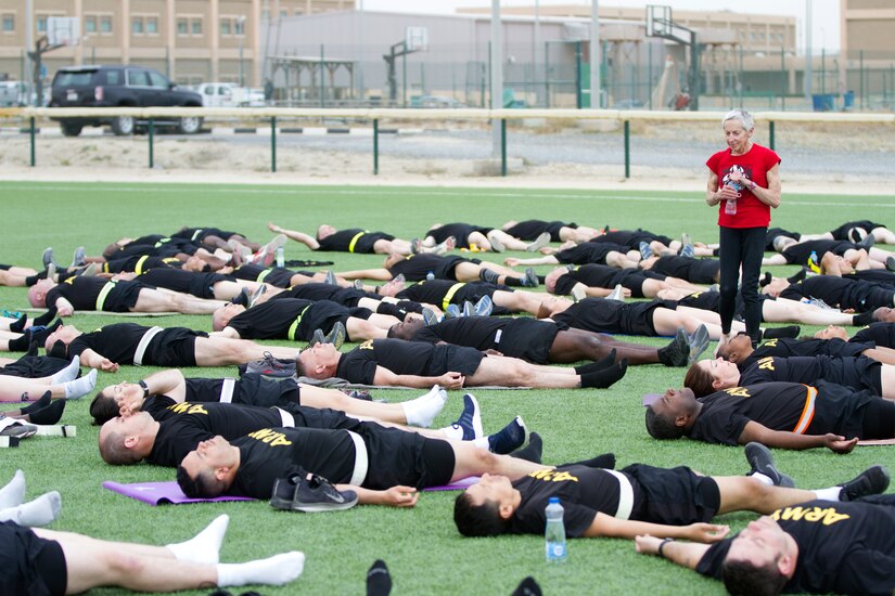 Paula LeBov, American Red Cross employee and Camp Arifjan Resiliency Program manager, guides Soldiers through a relaxation exercise during an early morning yoga class April 3, 2019 at Camp Arifjan, Kuwait.